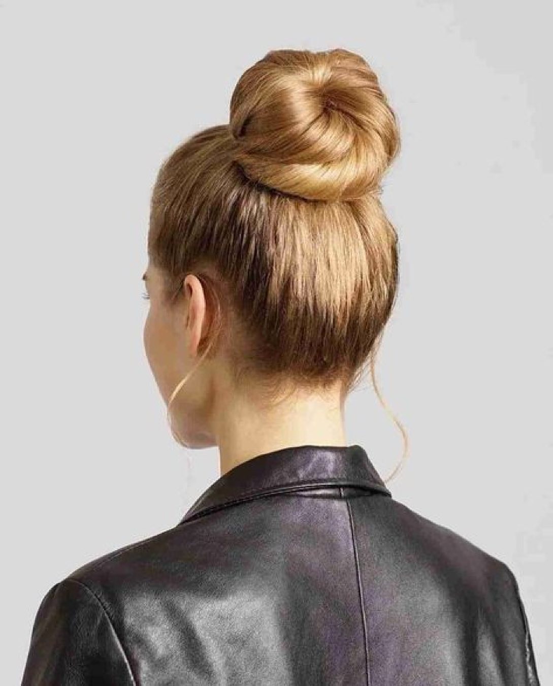 Sleek High Donut Bun with Soft Face‑Framing Tendrils