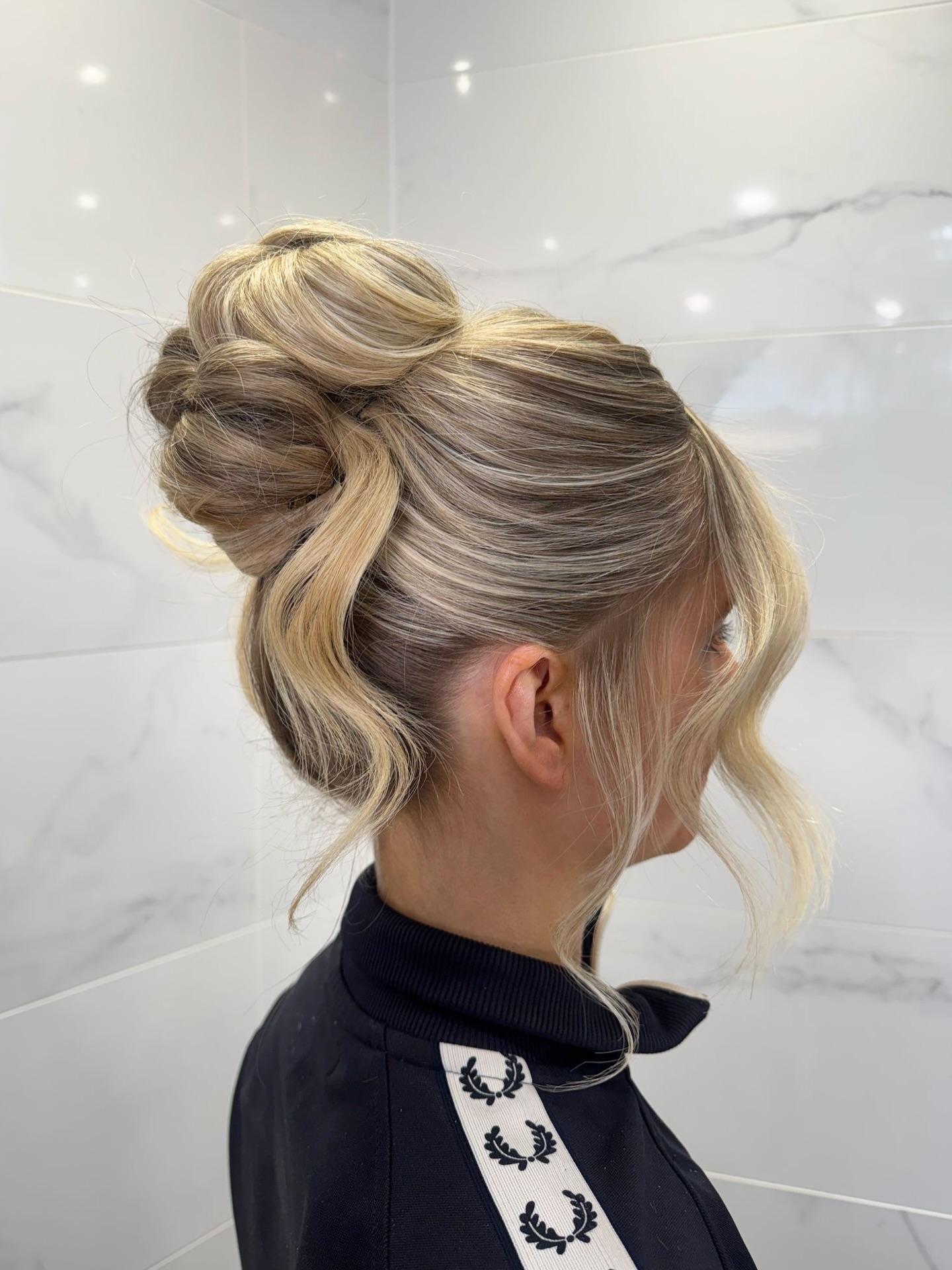 Twisted Sculptural Topknot with S-Shaped Face-Framing Tendrils