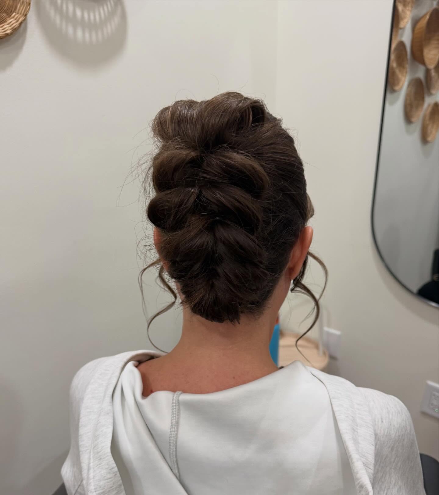 Voluminous Loop-Tuck Updo with Face-Framing Tendrils