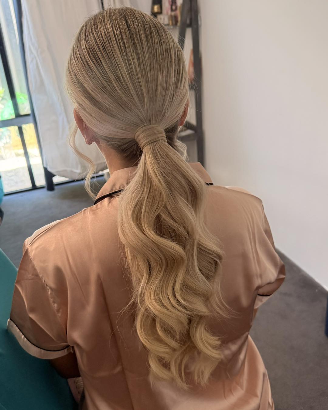 Wrapped Low Ponytail with Loose S-Waves and Face‑Framing Tendrils