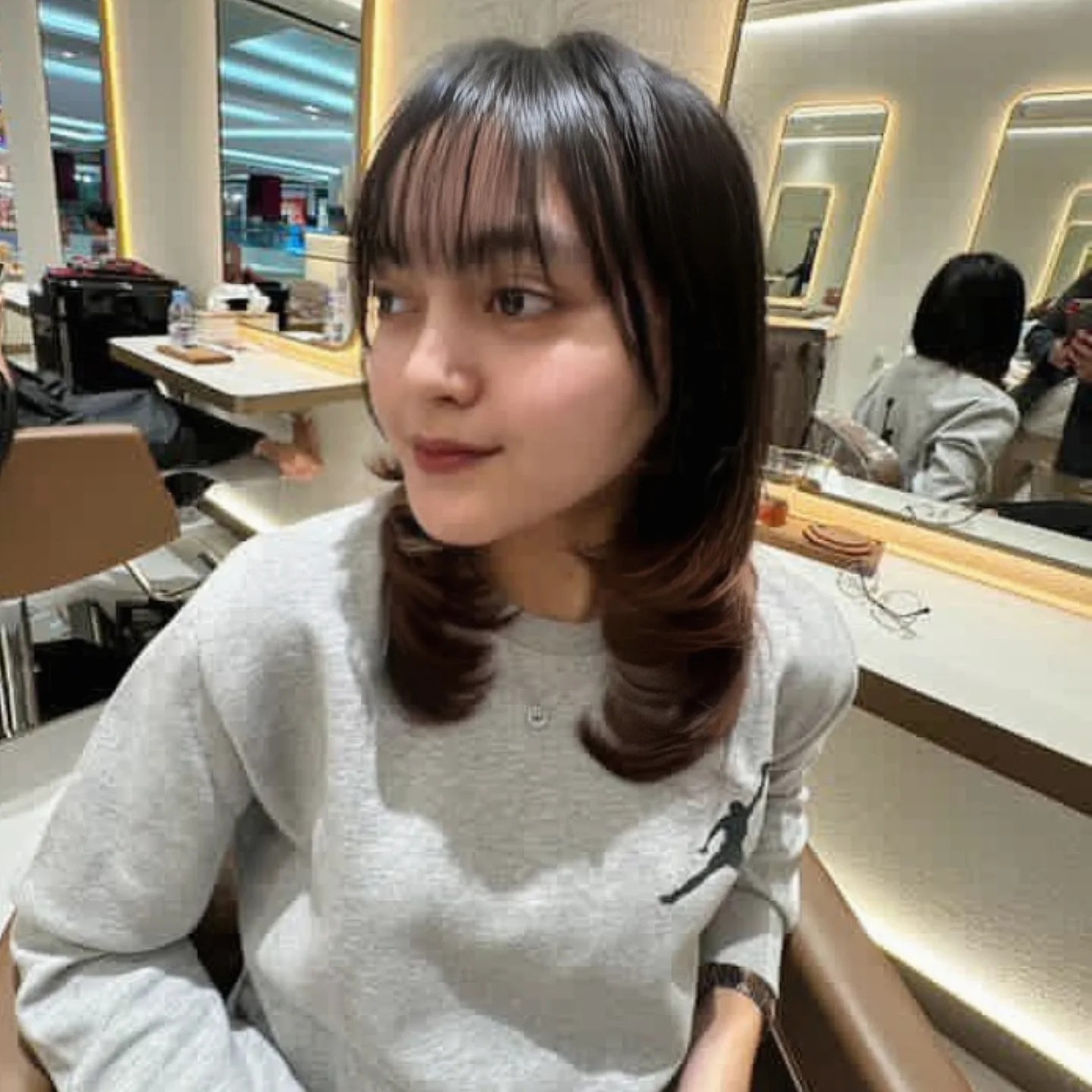 Feathered Shoulder-Length Flip with Wispy Short Bangs