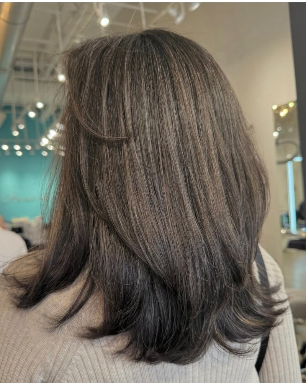 Layered Mid-Length Brunette with Grey Root-Melt and Feathered Ends