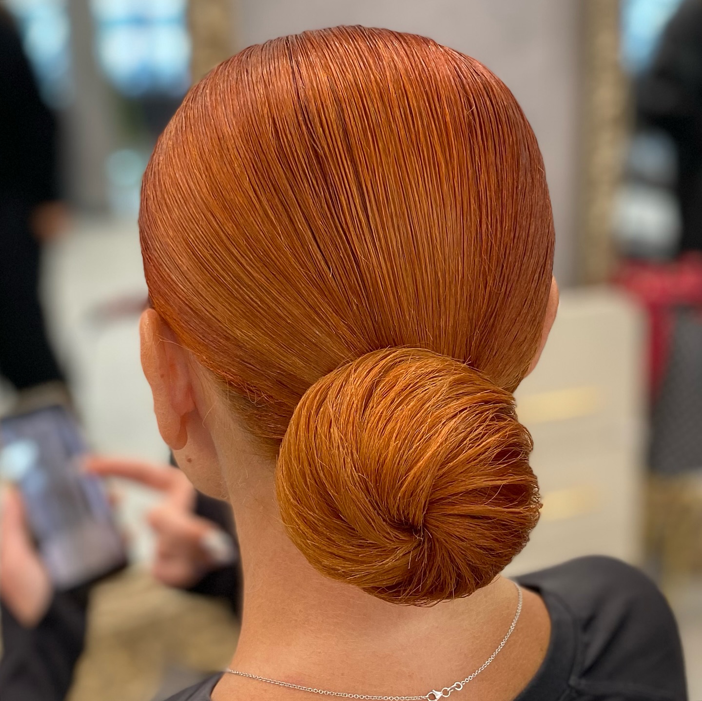 Sleek Copper Wrapped Low Bun with Radial Combing