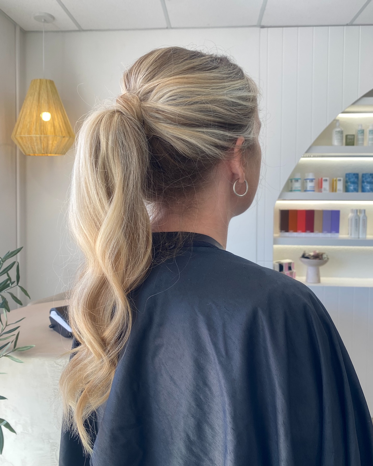 Brushed-Back Wrapped High Pony with Painted Blonde Balayage