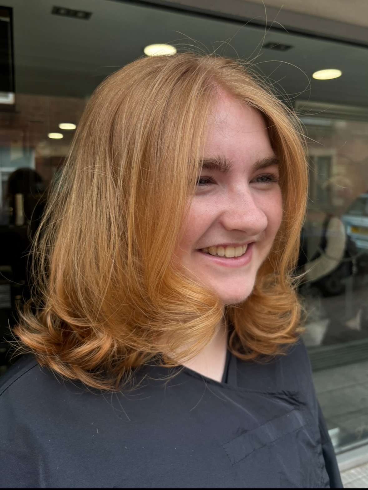 Strawberry Copper Shoulder-Length Cut with Curtain Frame and Rounded Blowout