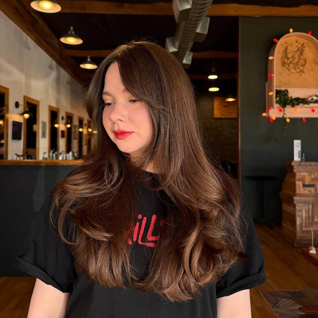 Warm Chocolate Long Layers with Side-Swept Fringe and Round Blowout