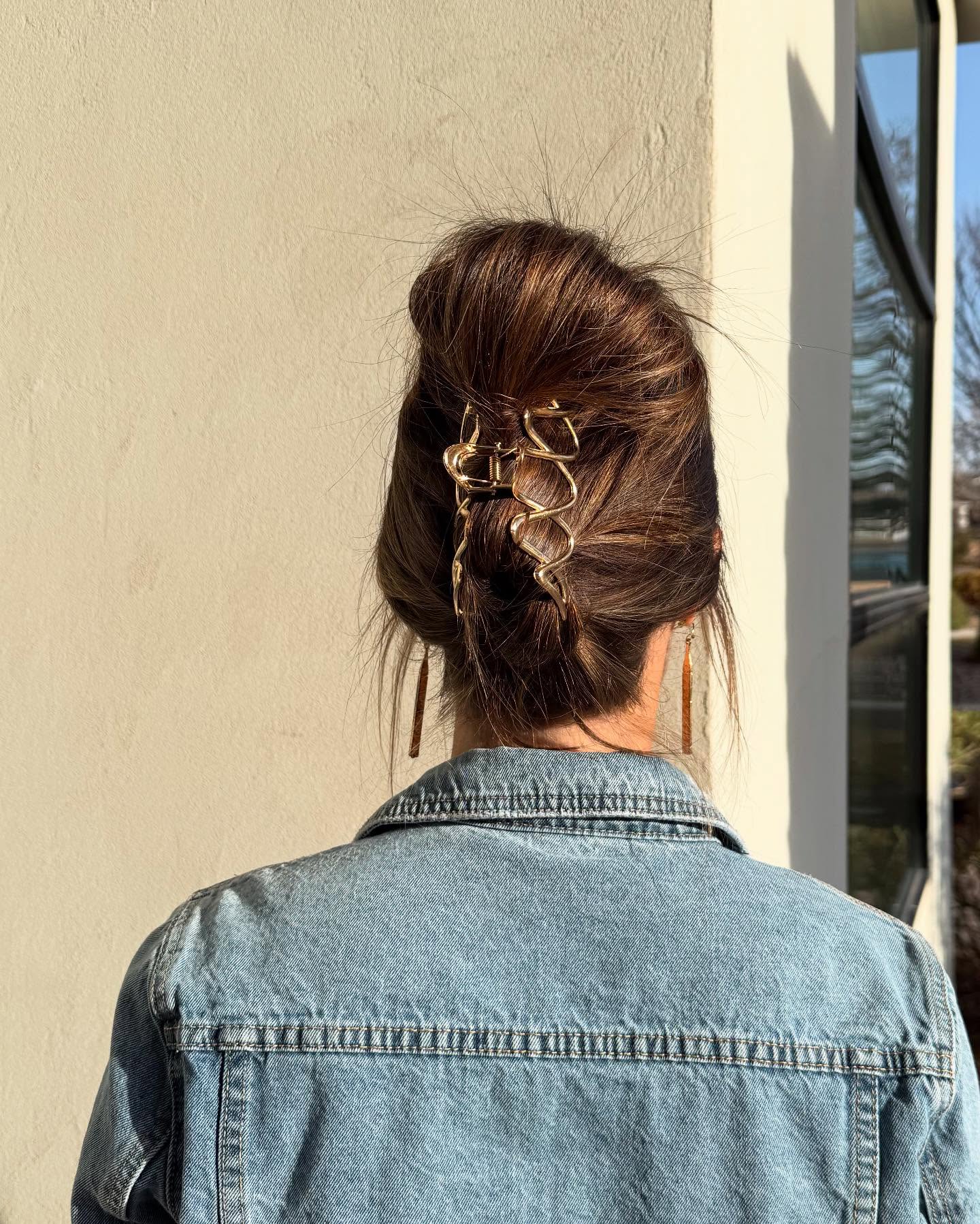 Low French Twist with Gold Claw Clips and Subtle Balayage