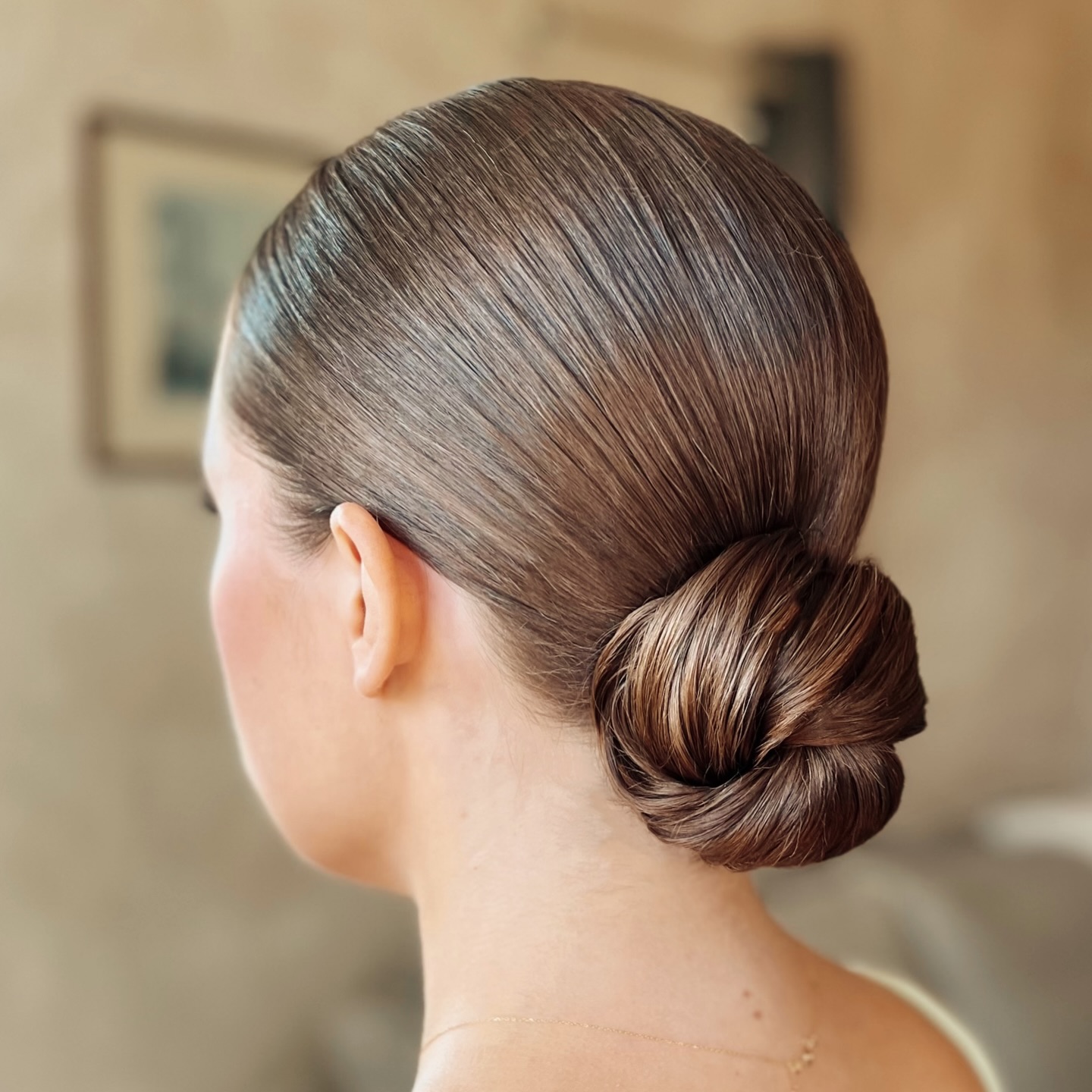 Polished Low Wrapped Bun with Satin Brunette Sheen