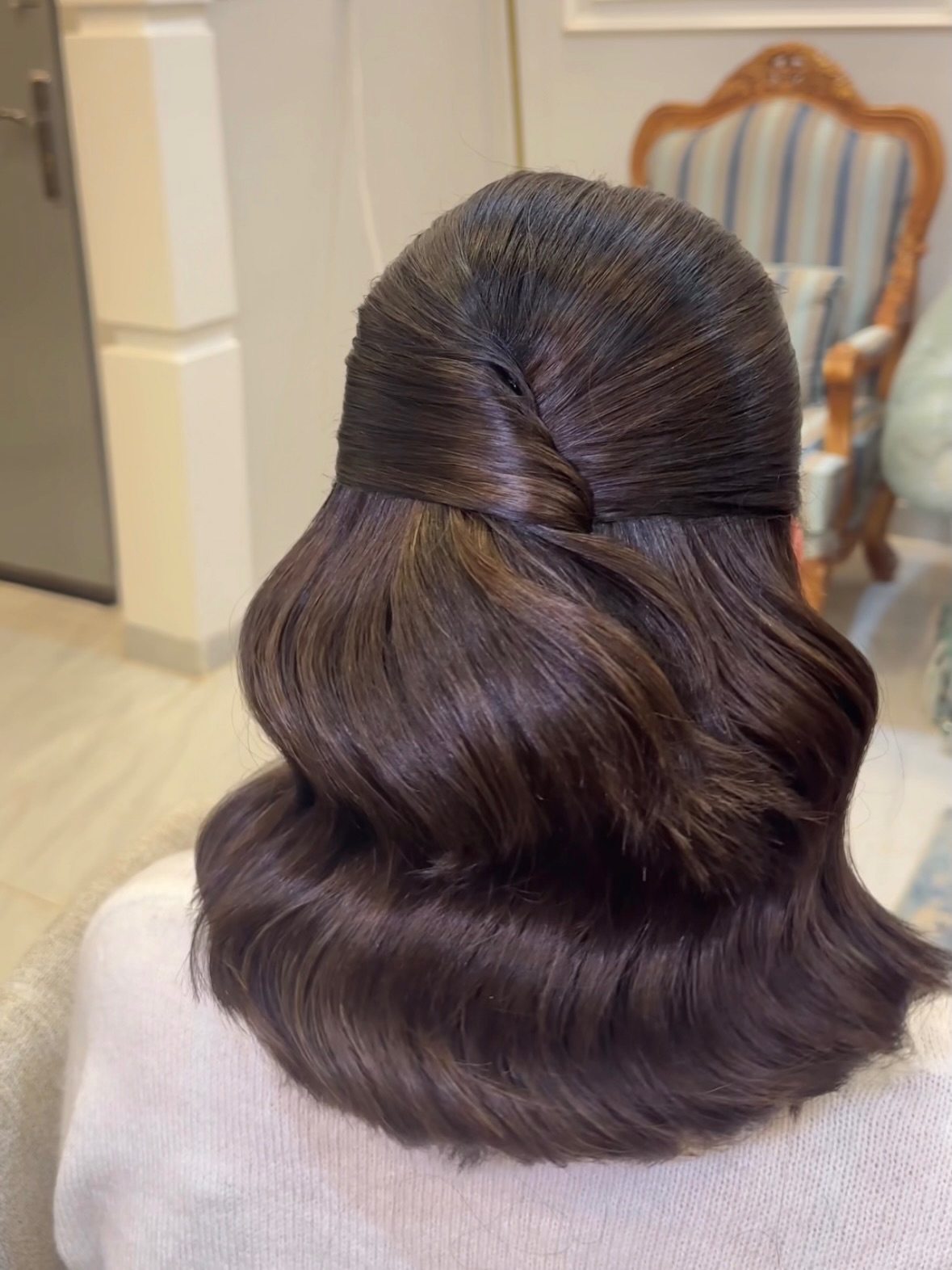 Sleek Half-Up Twisted Seam with Barrel Waves