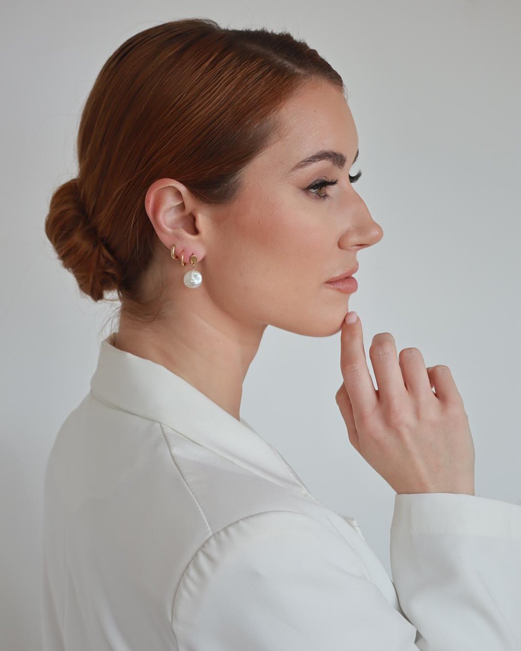 Sleek Low Twisted Bun with Warm Copper Shine
