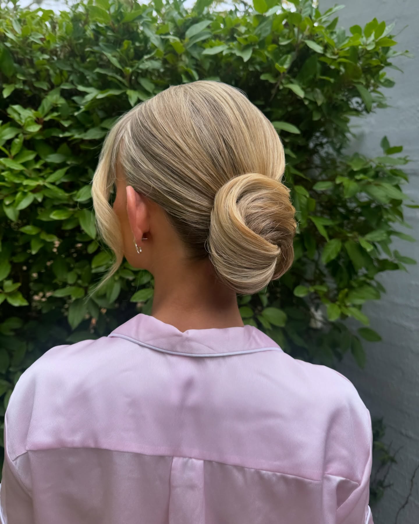 Sleek Rolled Low Chignon with Face-Framing Tendril