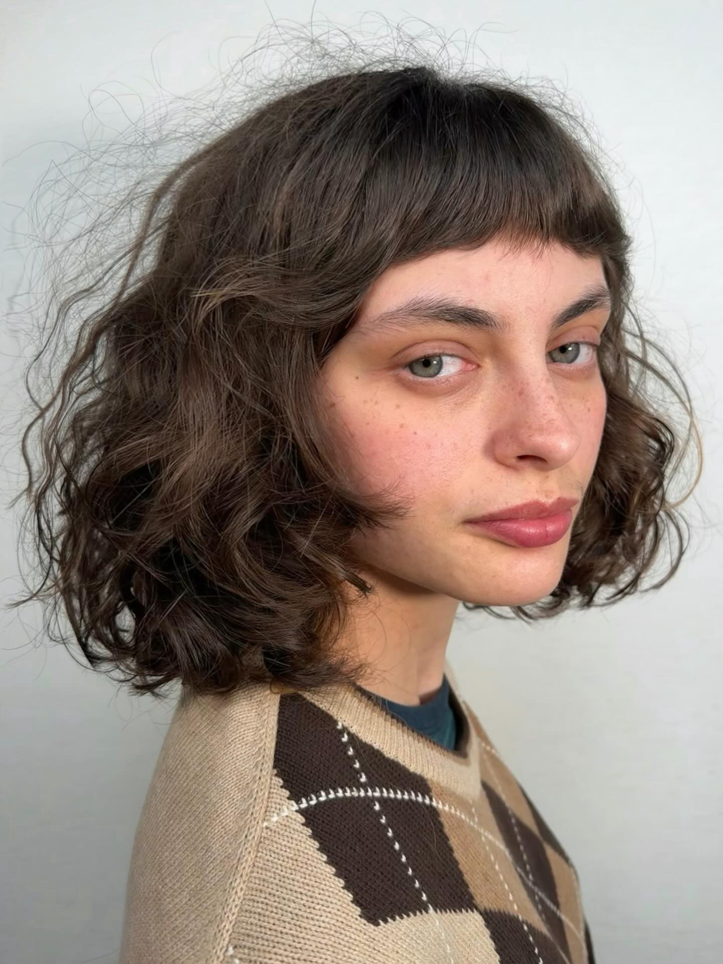 Soft Curly Chin-Length Bob with Micro Blunt Fringe