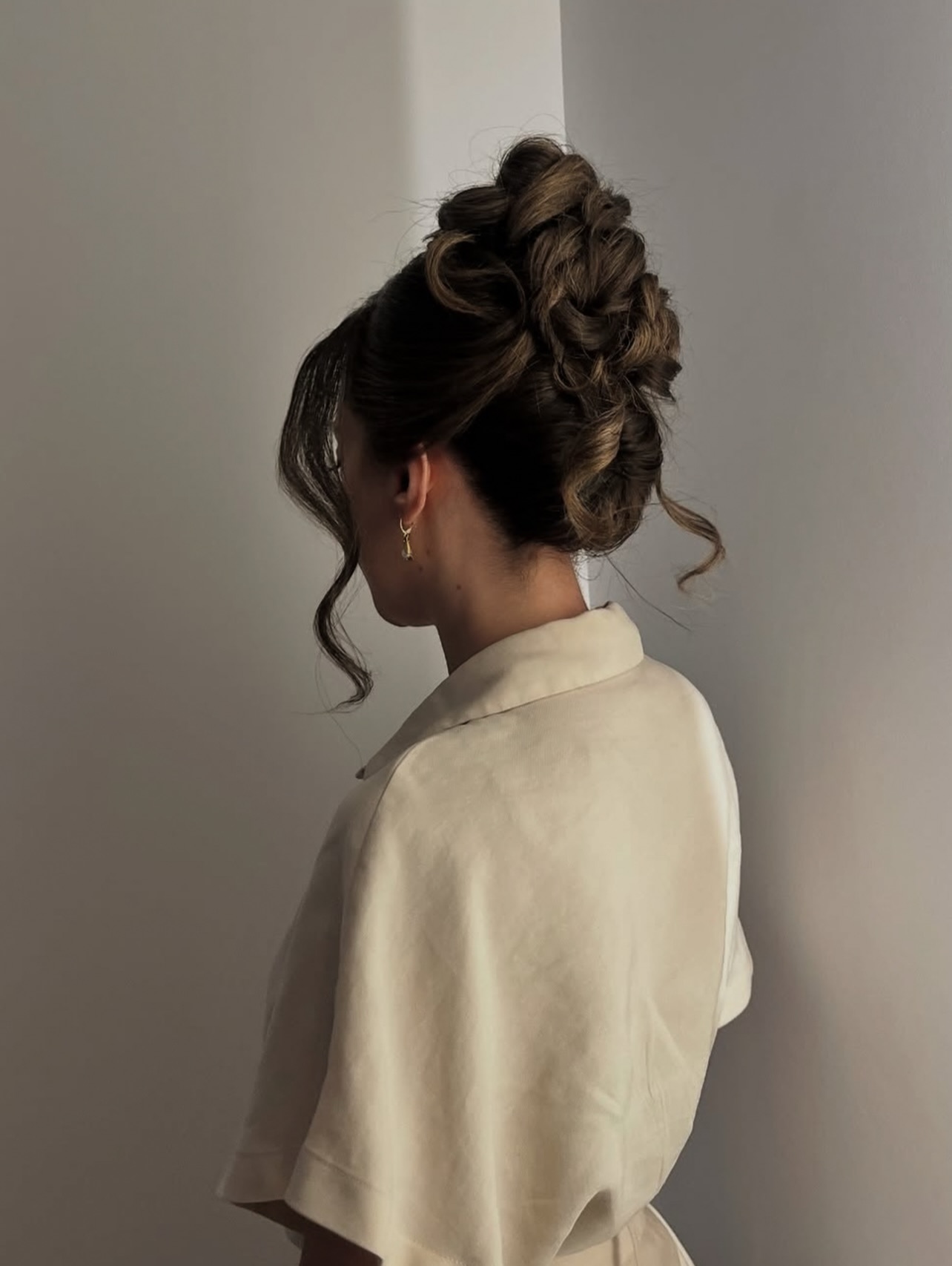 Structured Twisted High Updo with Soft Face-Framing Curls