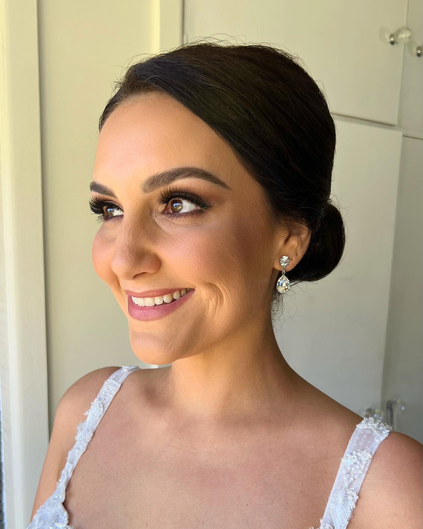 Sleek Low Chignon with Deep Side Part and Glossy Finish
