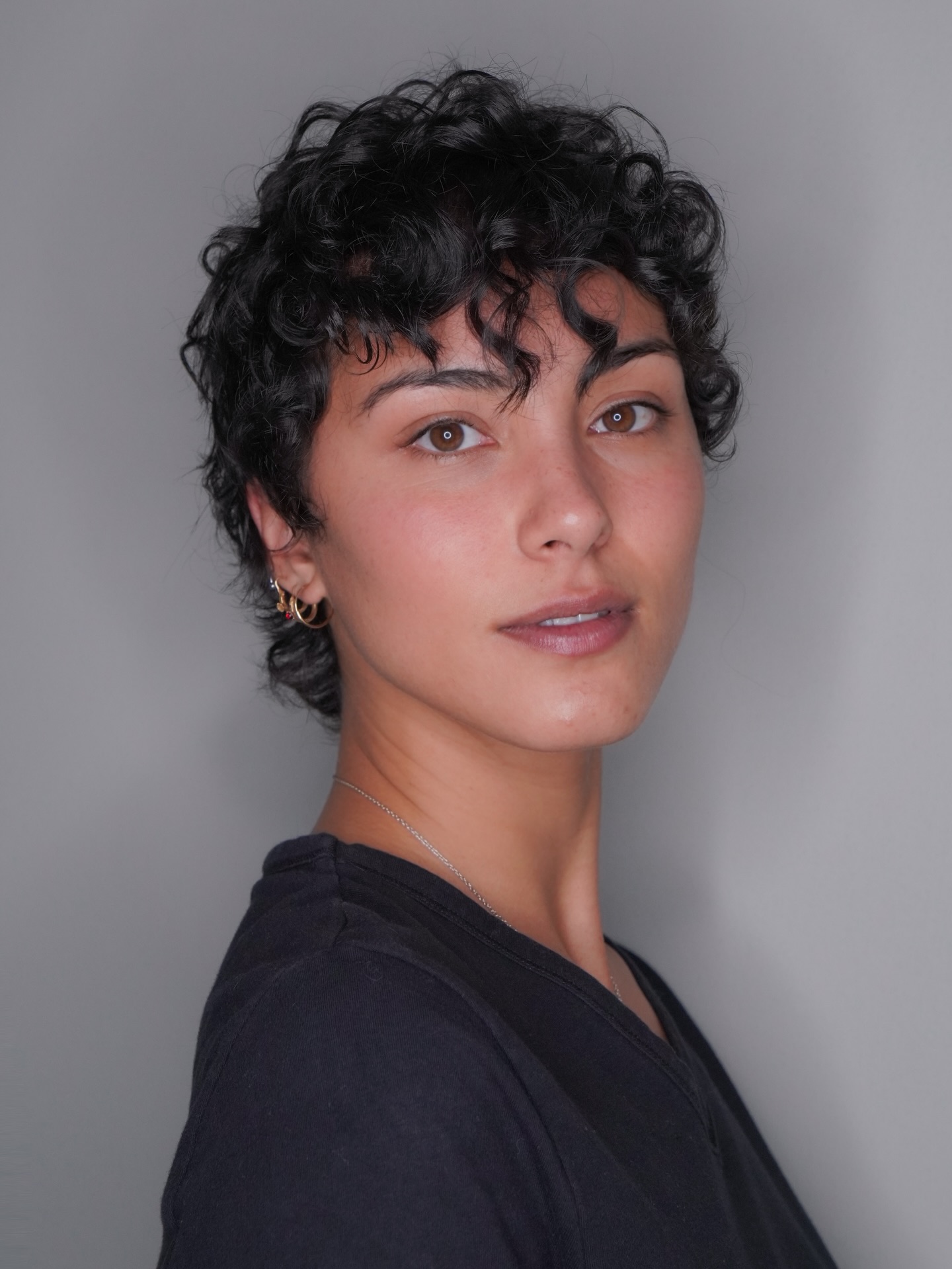 Short Curled Pixie with Defined Ringlet Fringe and Tapered Nape