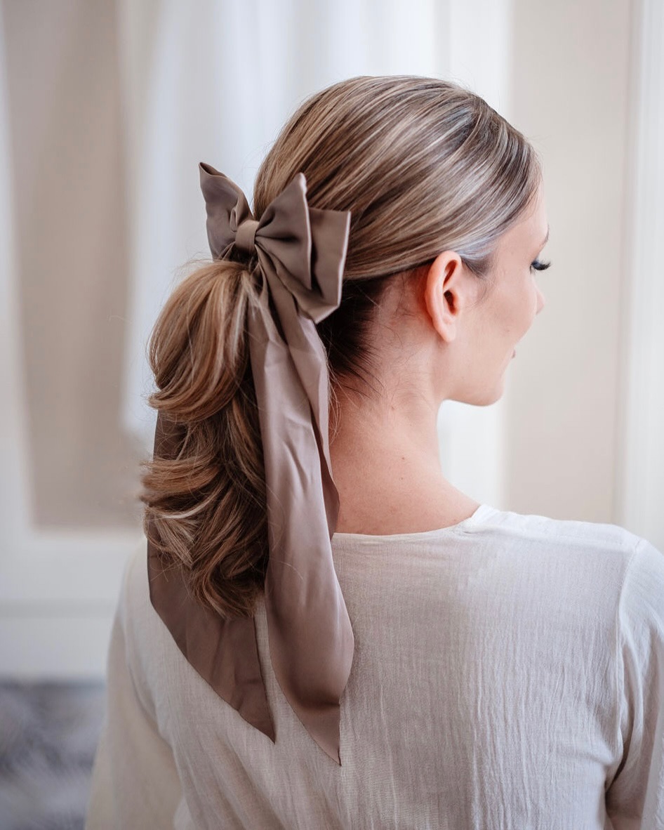 Soft Ash Blonde Low Pony with Nape-Tapered Layers