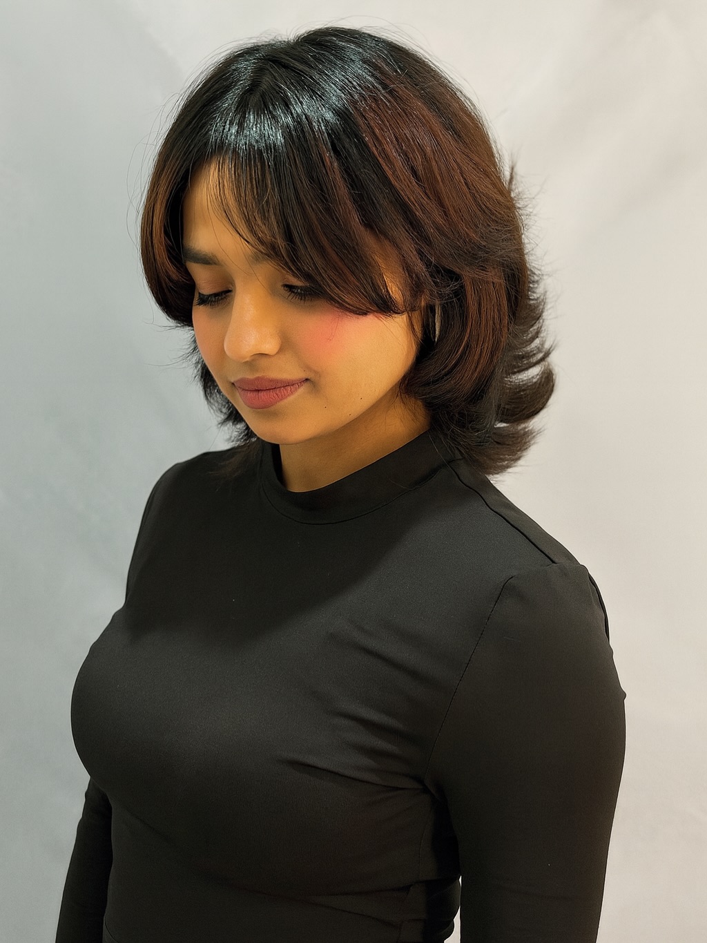 Feathered Neck-Length Wolf Cut with Curtain Bangs and Auburn Balayage