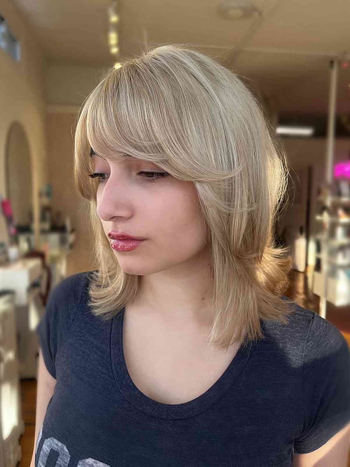 Light Blonde Layered Cut with Soft Bangs