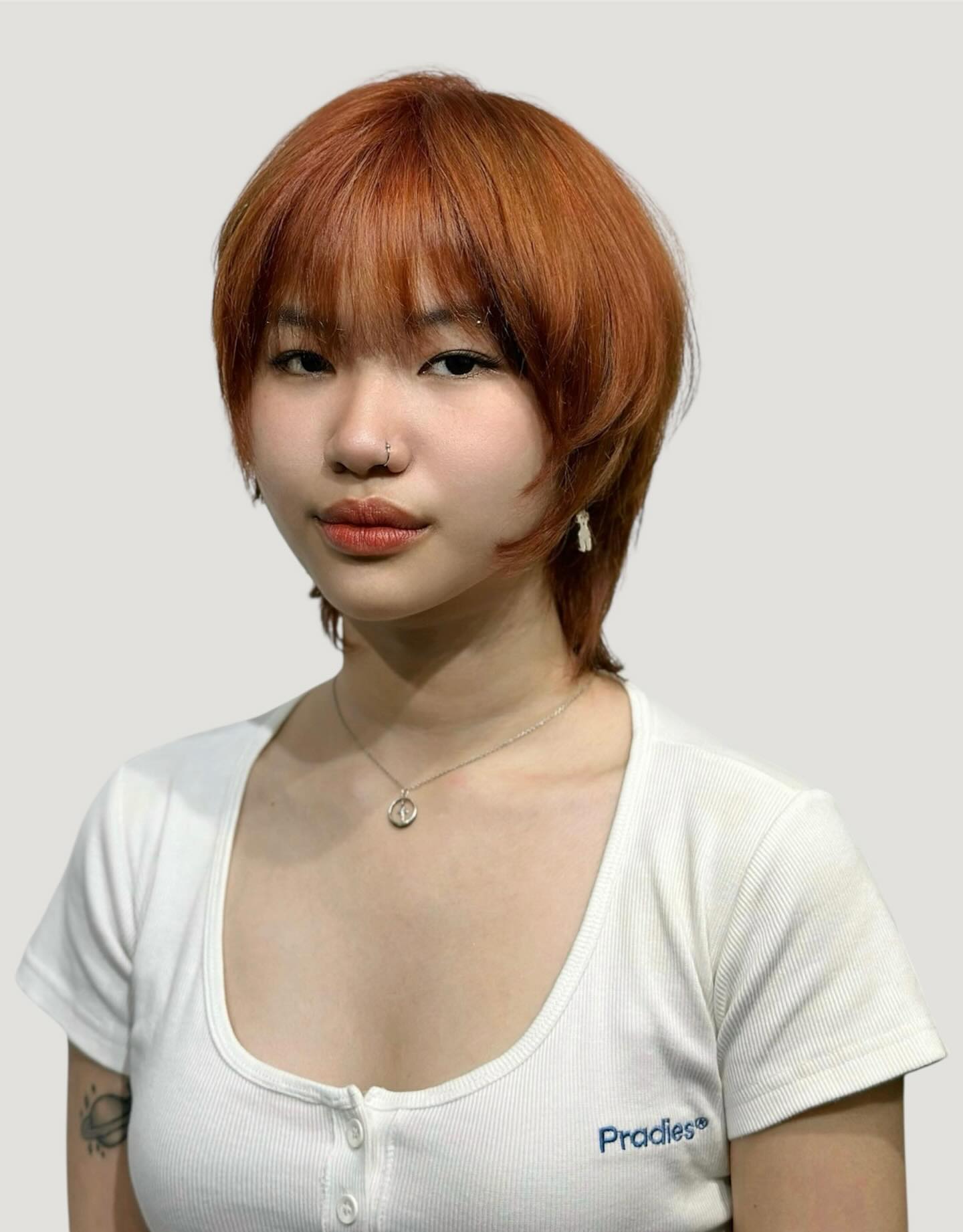 Rounded Copper Shag with Face-Framing Fringe and Nape Taper