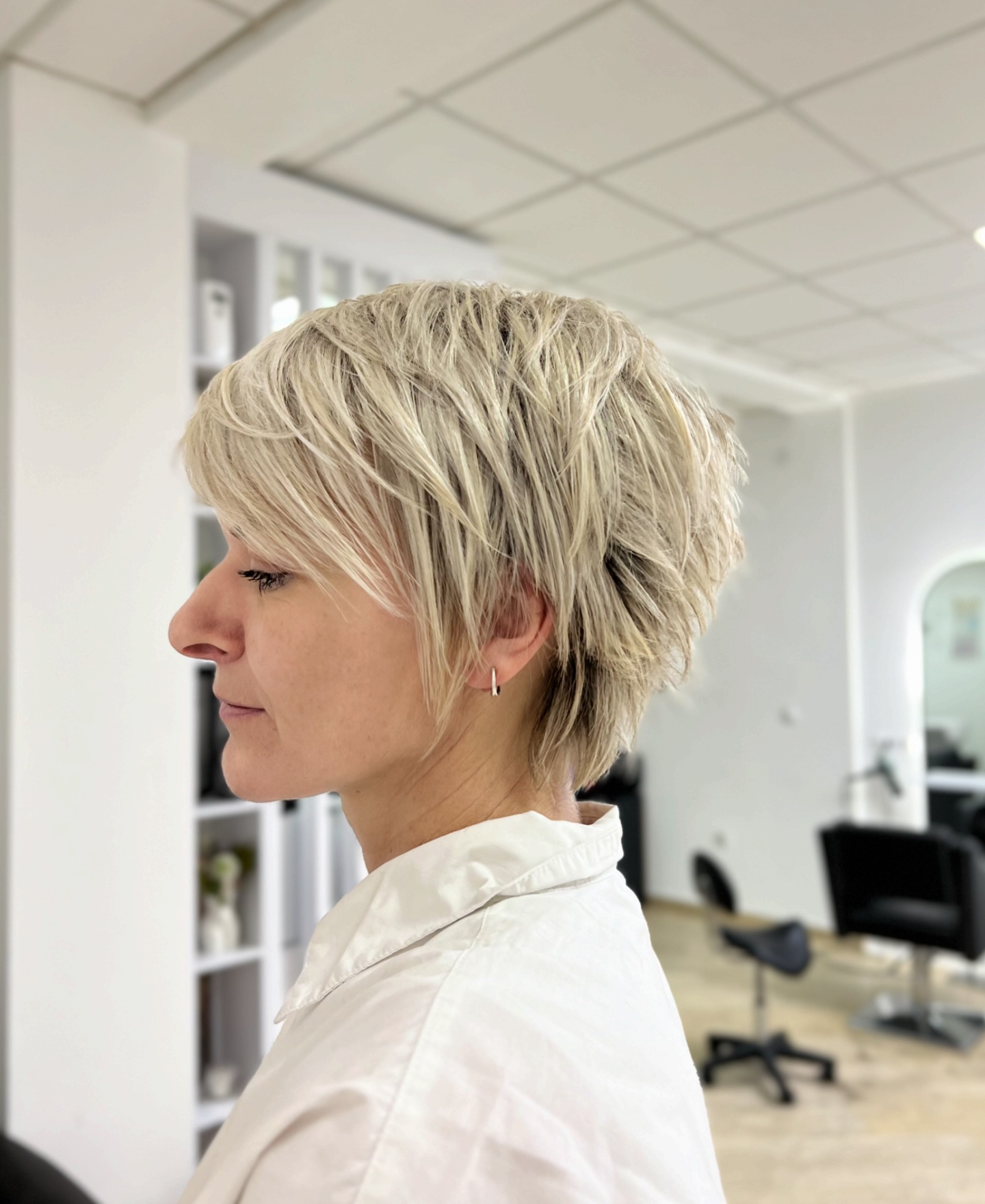Platinum Layered Pixie with Long Side-Swept Fringe and Graduated Nape