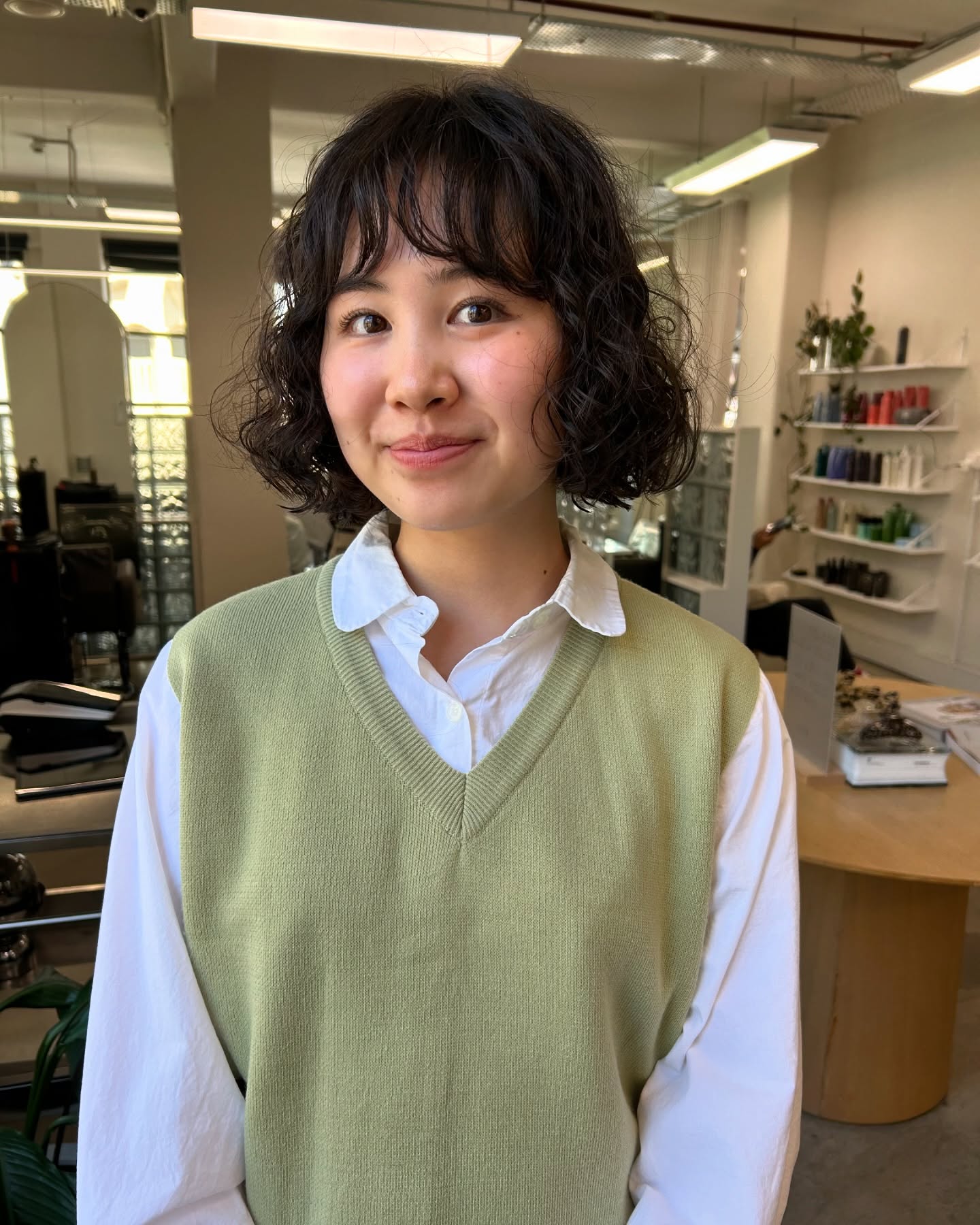 Playful Chin-Length Curly Bob with Broken Curtain Fringe