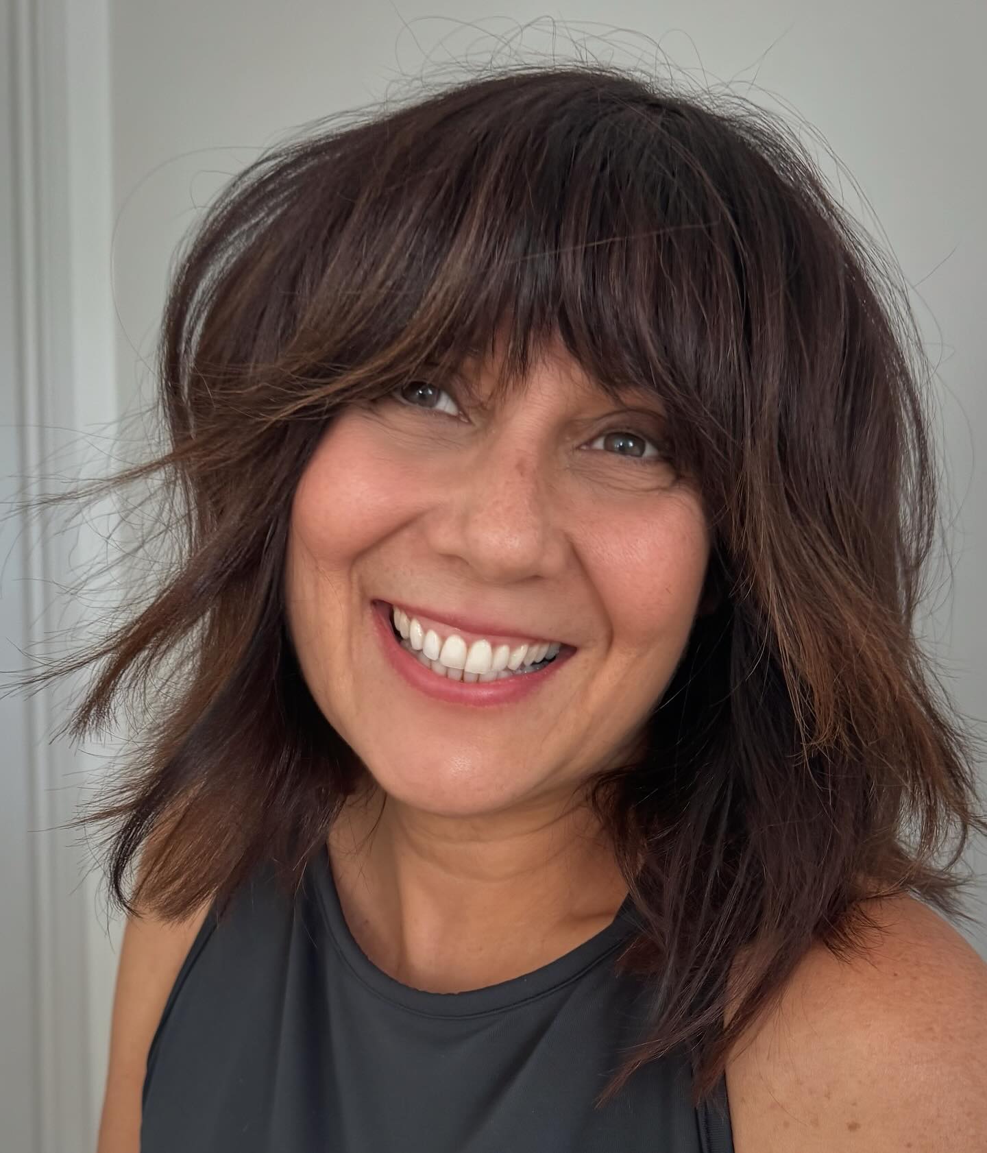 Choppy Shoulder-Length Bob with Full Fringe and Sliced Highlights