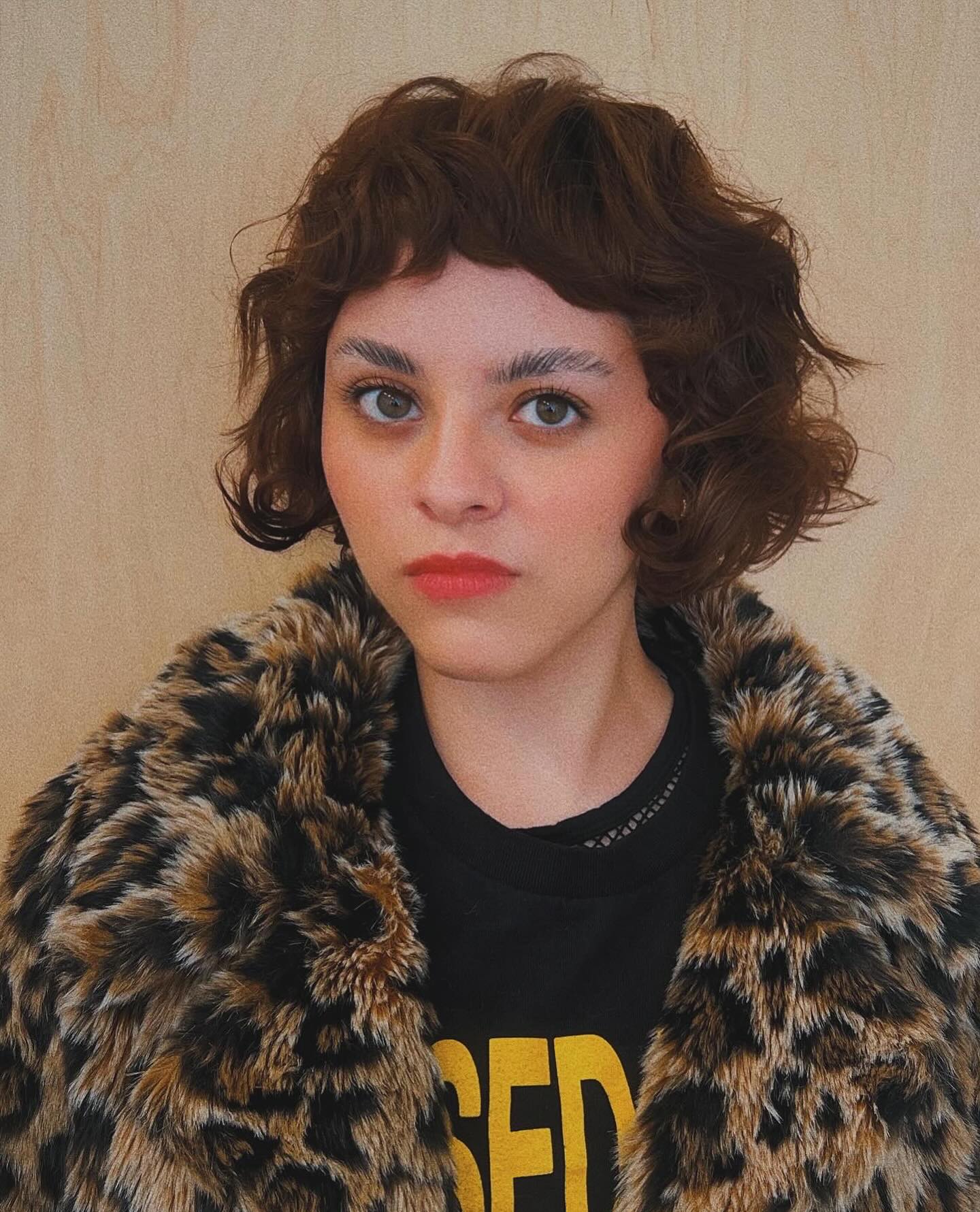 Razor-Textured Chin-Length Curly Bob with Mini Blunt Fringe