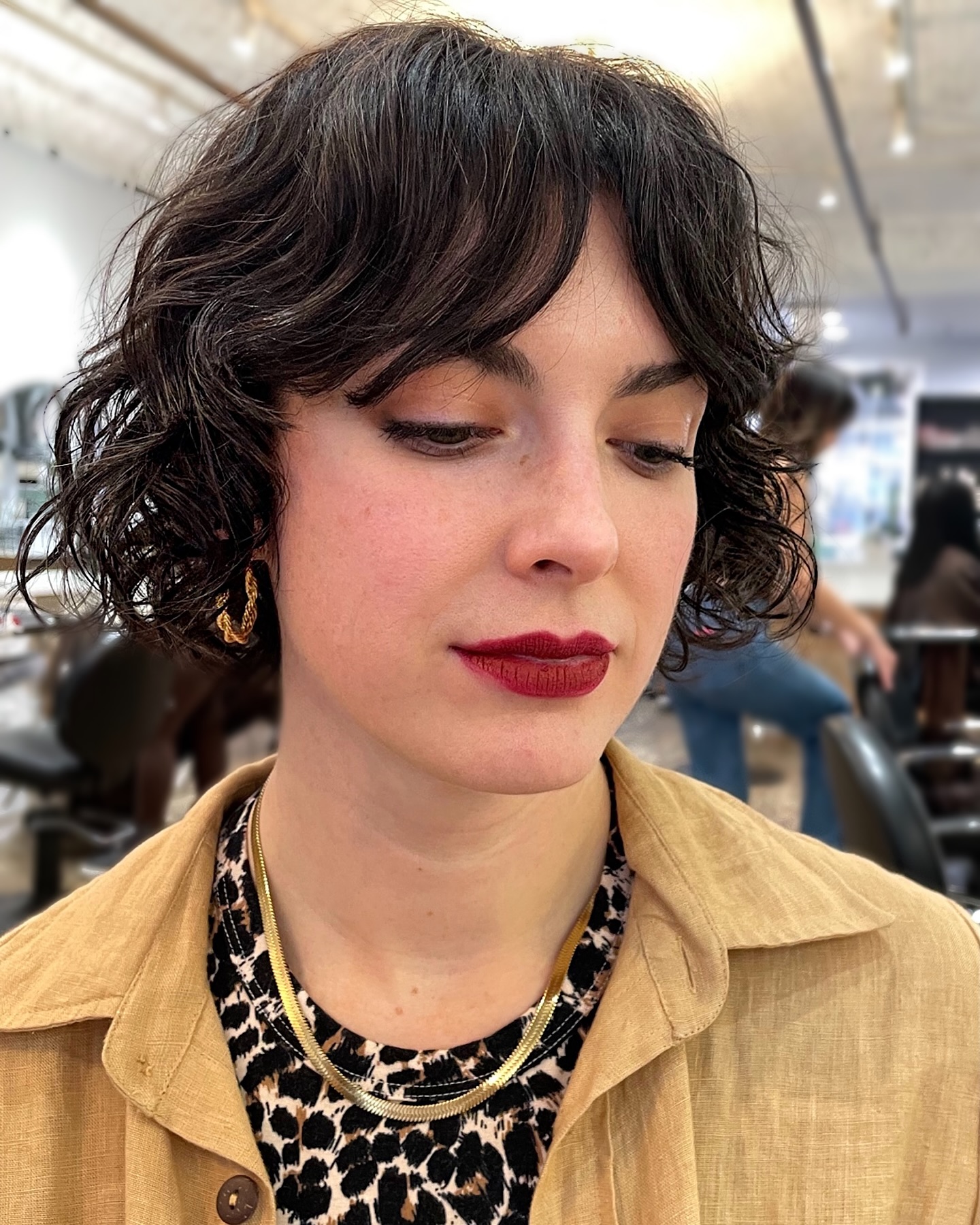 Textured Razored Curly Chin-Length Bob with Gentle Curtain Fringe