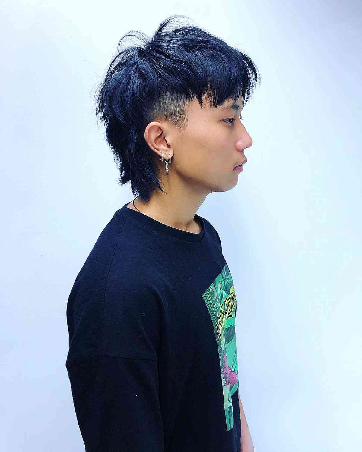 Edgy black mullet haircut with gender neutral undercut