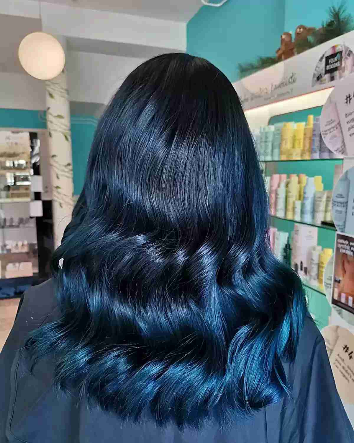 Glossy Blue Black Balayage Hair with Medium-Length Cut and Soft Waves