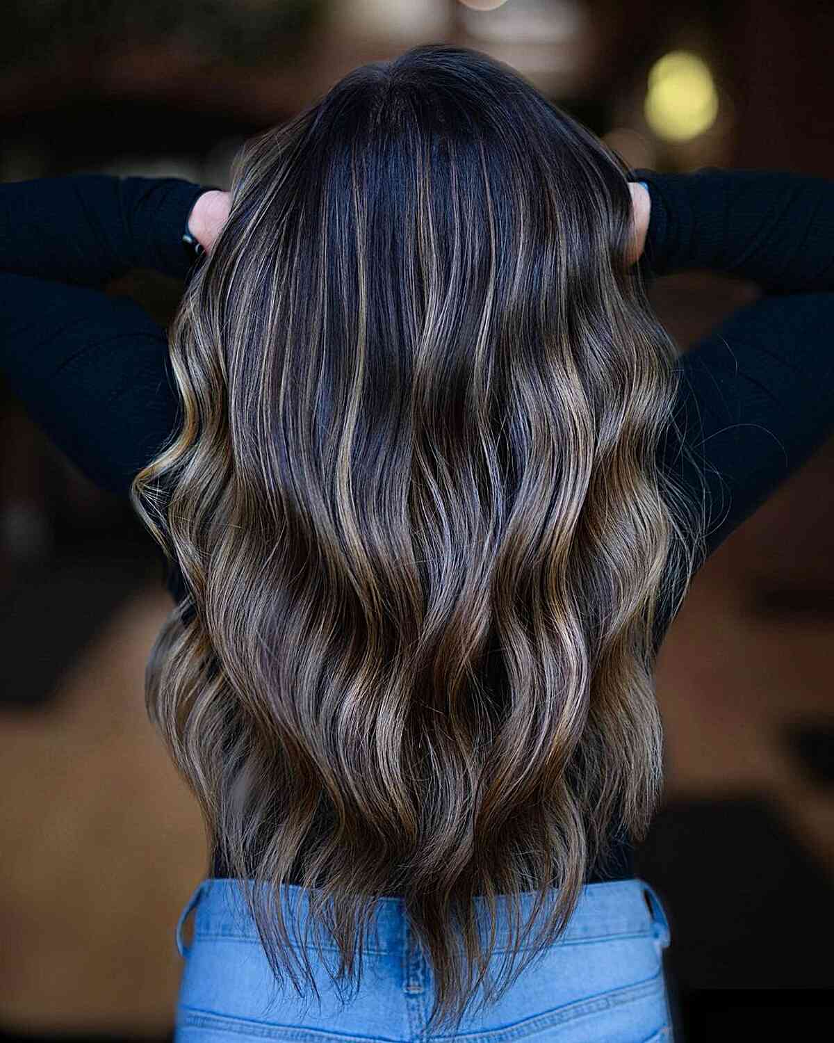 Glossy Dark Brown Balayage with Blonde Tones for women with long wavy hair