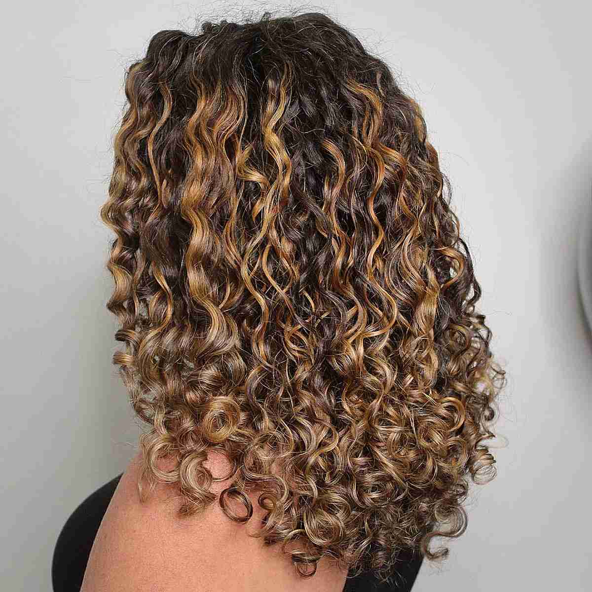 Golden Balayage Highlights on Curly Dark Brunette Hair