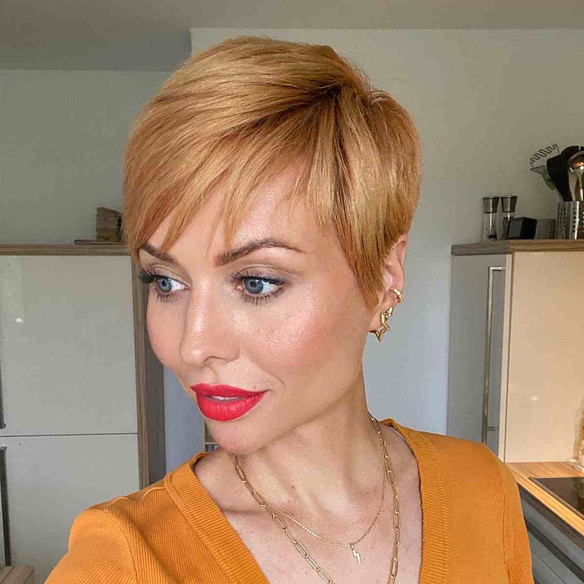 Golden Blonde Pixie Cut with Side-Swept Bangs for 40-Year-Olds