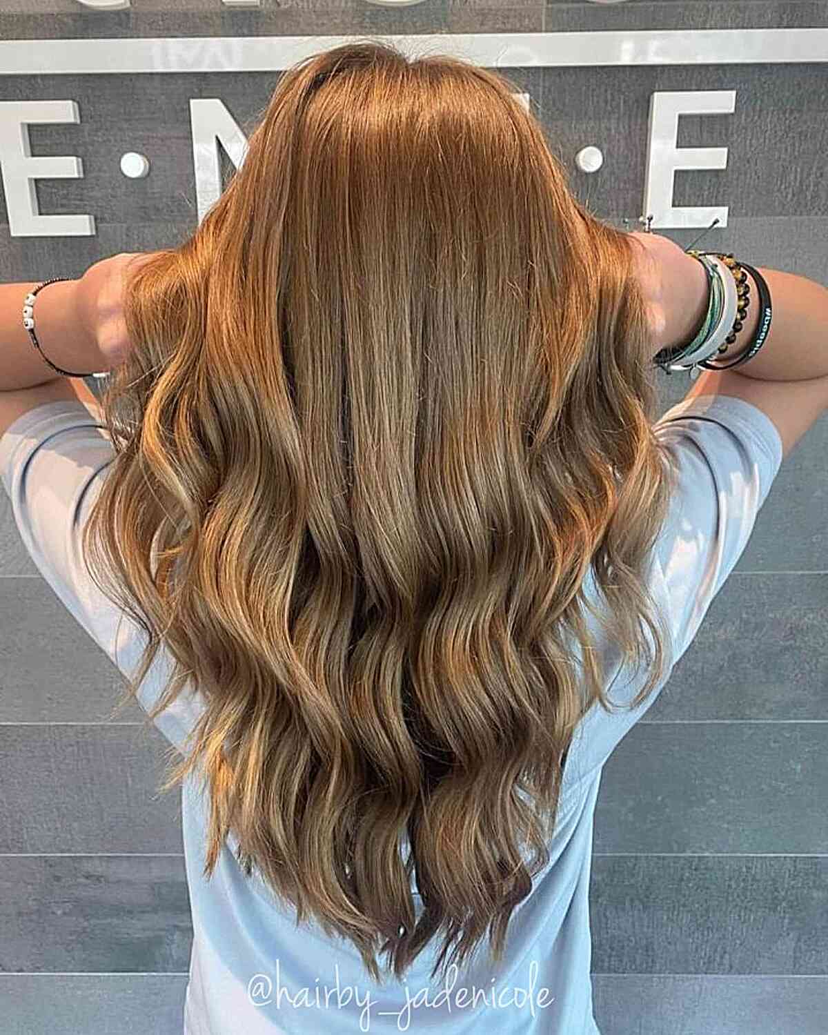 Golden Brown for a Waist-Length V Layered Haircut with Waves