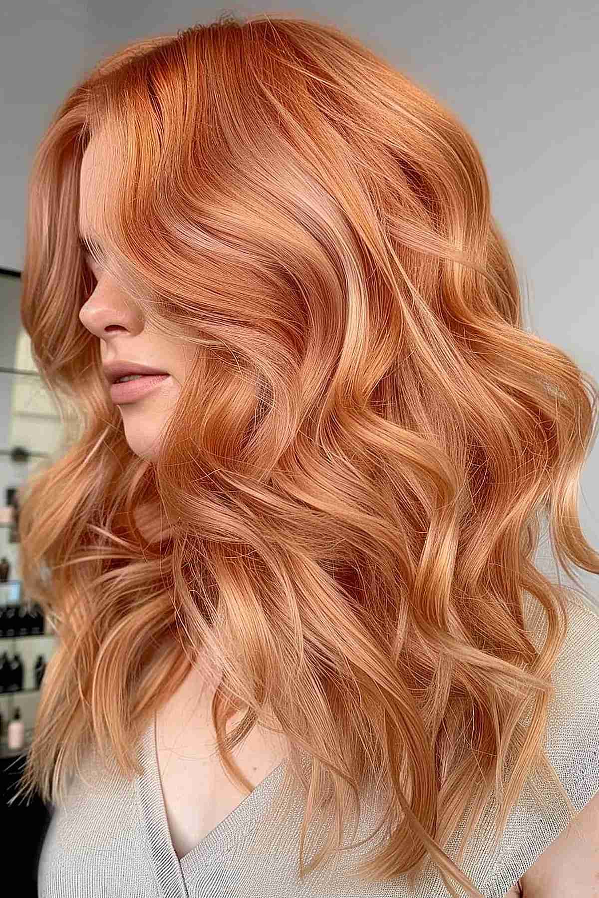 Luxurious golden peach long waves, adding dimension and luminosity to the hair, ideal for those seeking a glamorous and eye-catching style.