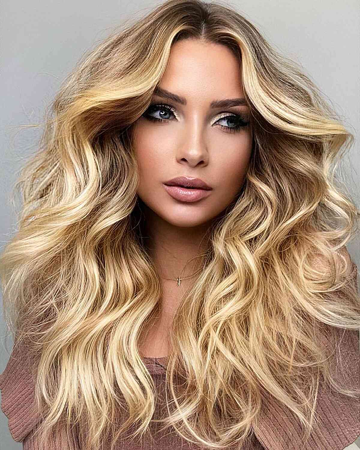Gorgeous Blonde Blowout with a Middle Part for women with long layered hair