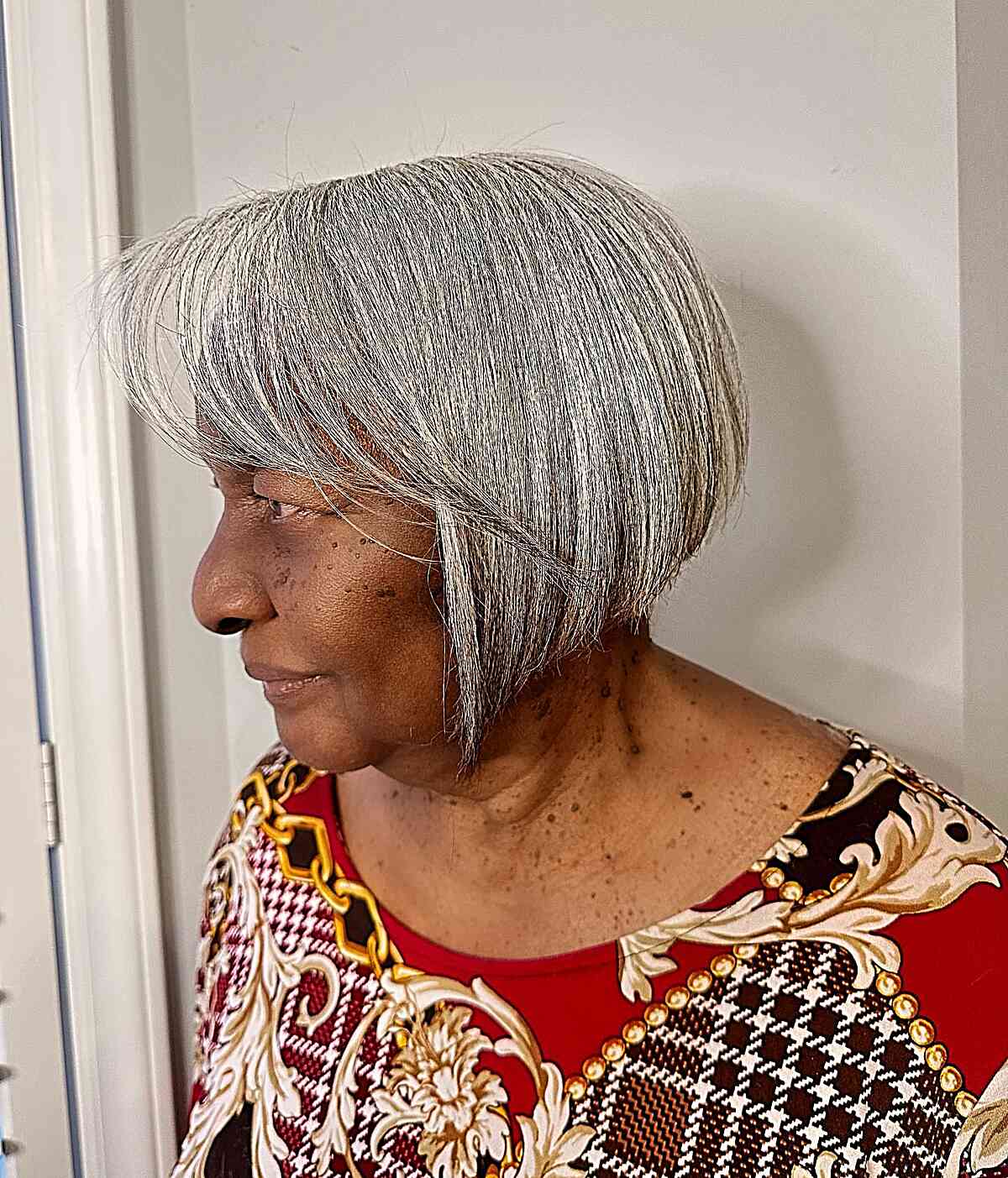 Jaw-Length Graduated Silver Bob with Side Bangs for Older Women
