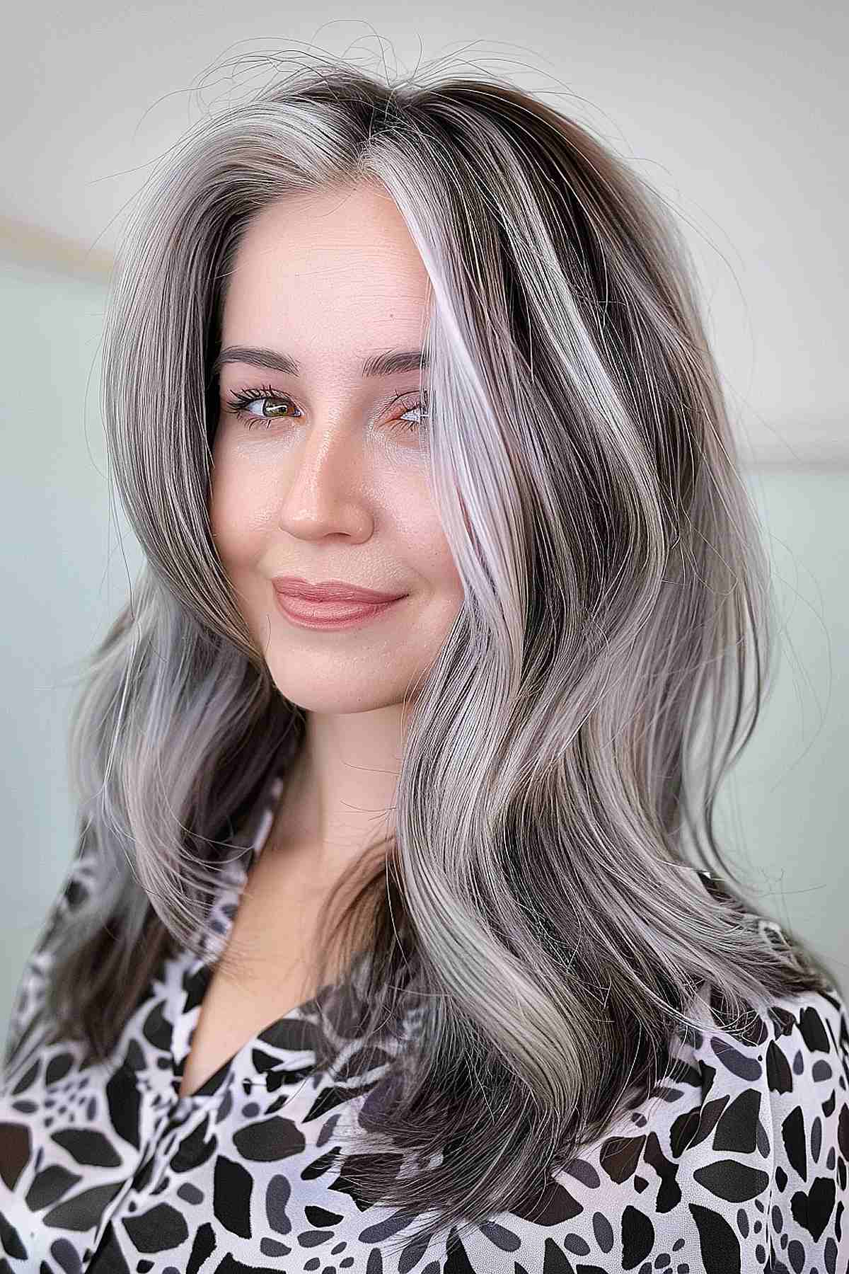 Medium-length hair with gray-blonde chunky highlights and soft waves