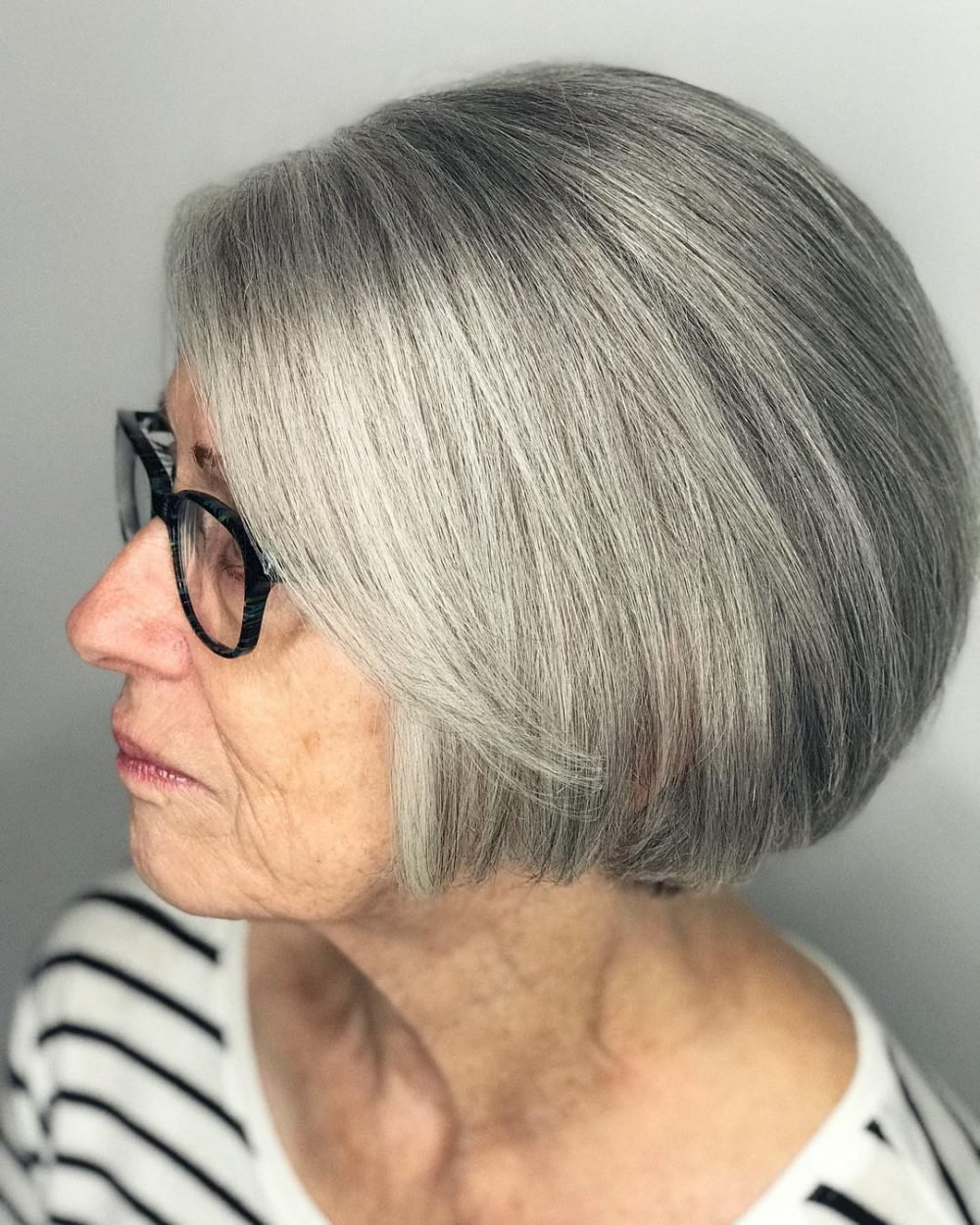 Short gray hairstyle for women over 60 with glasses