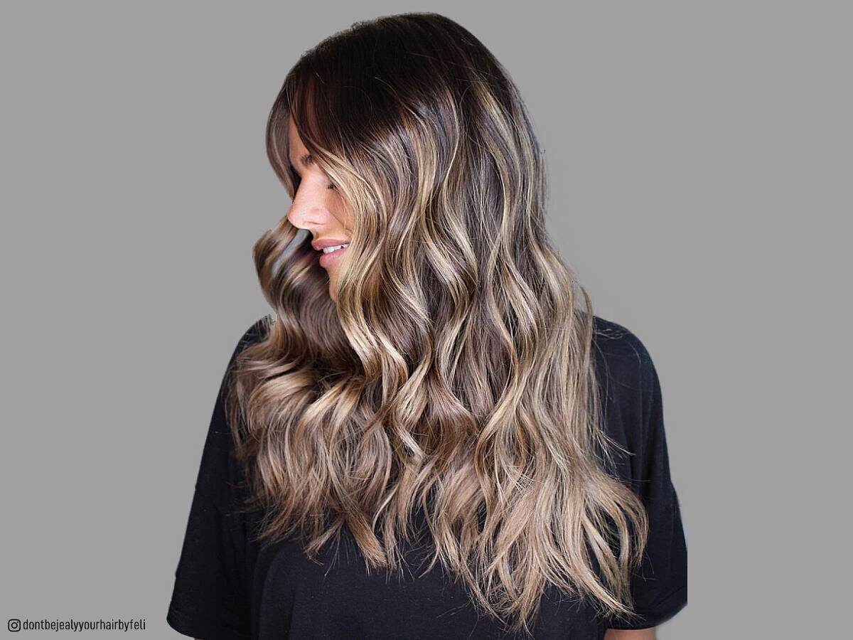 Golden blonde highlights on long hair and tan skin