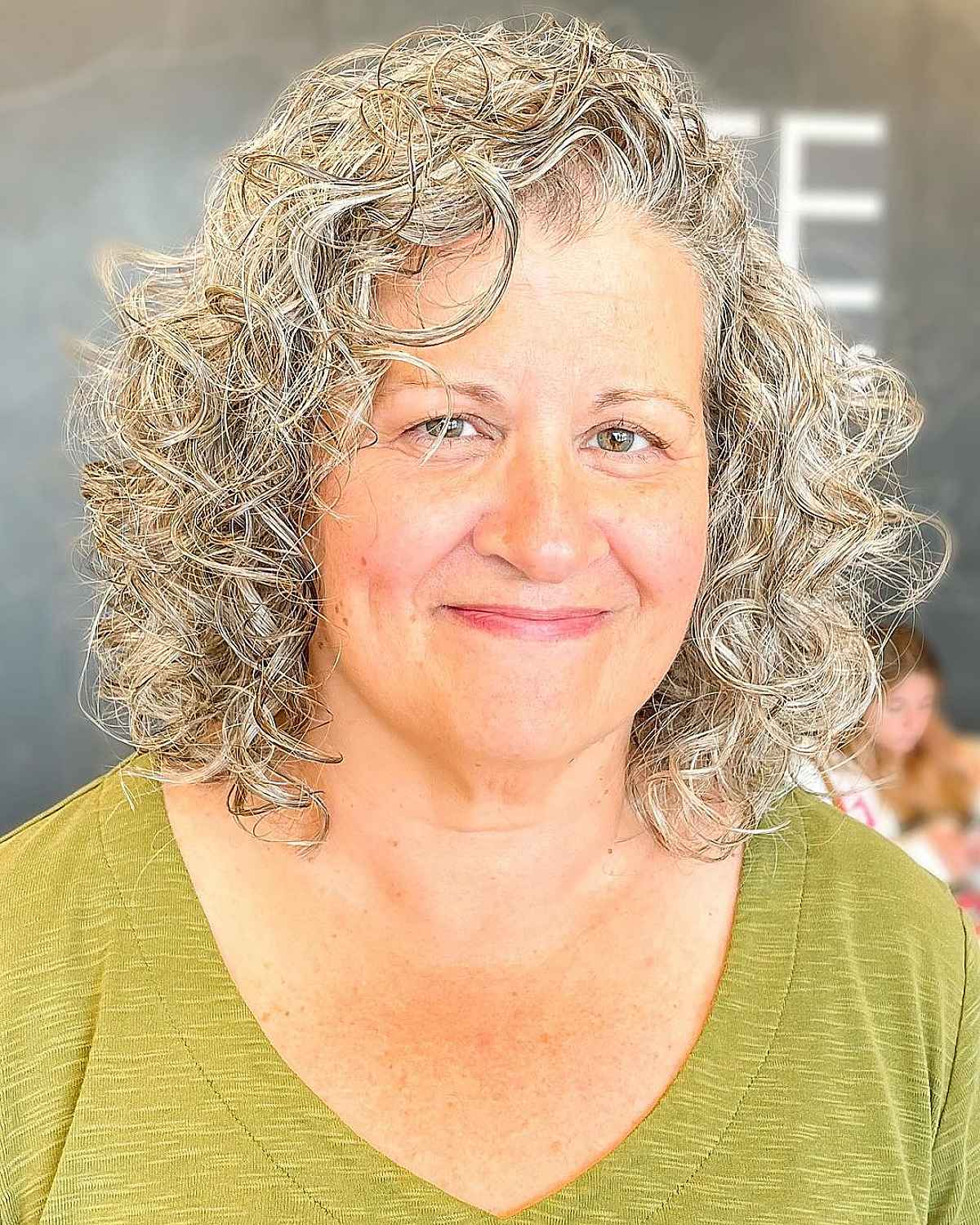 Shoulder-length haircut for ladies in their 50s with Curly Hair