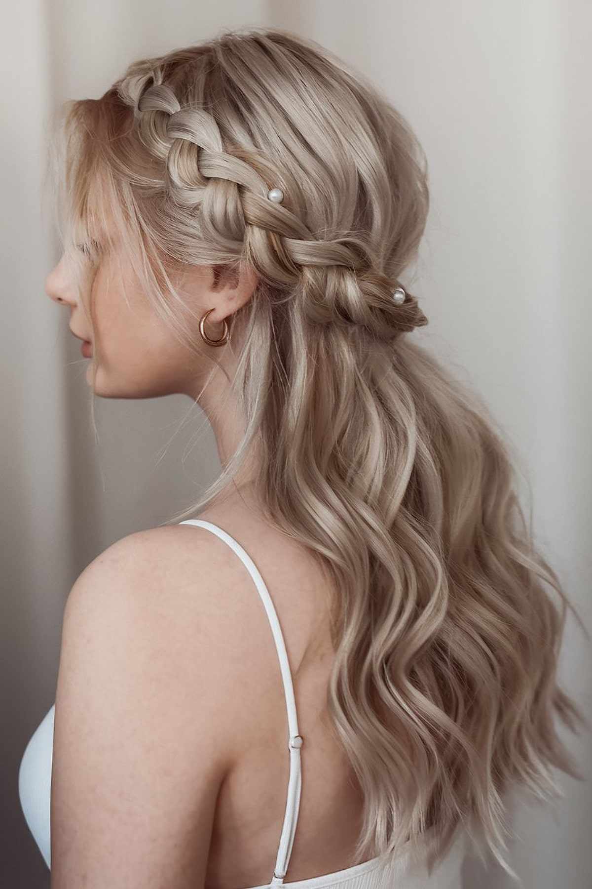 Half-up braided hairstyle with loose waves for homecoming