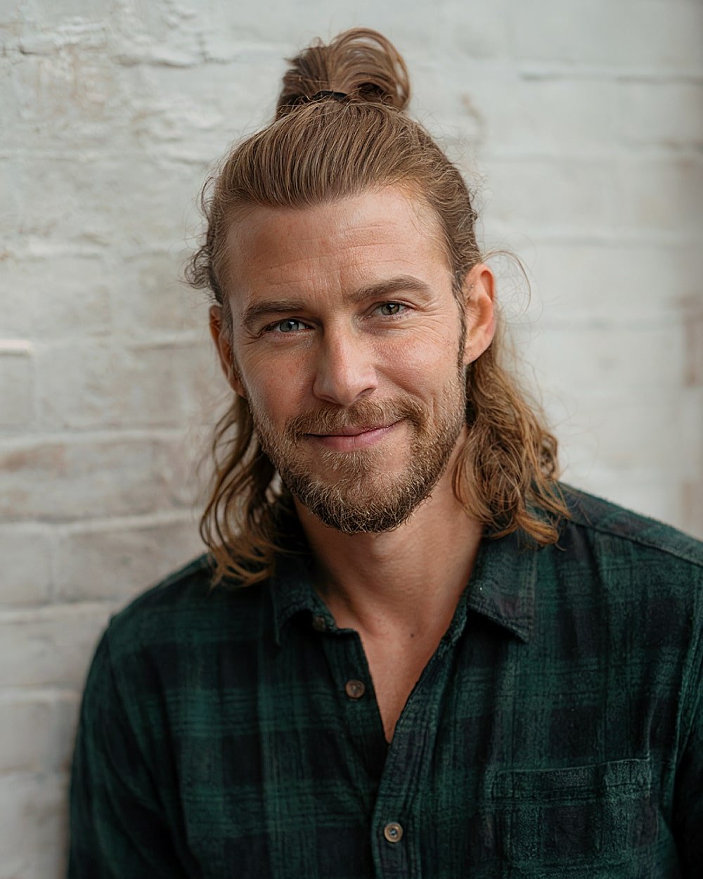 Half up half down men’s hairstyle with tied top section