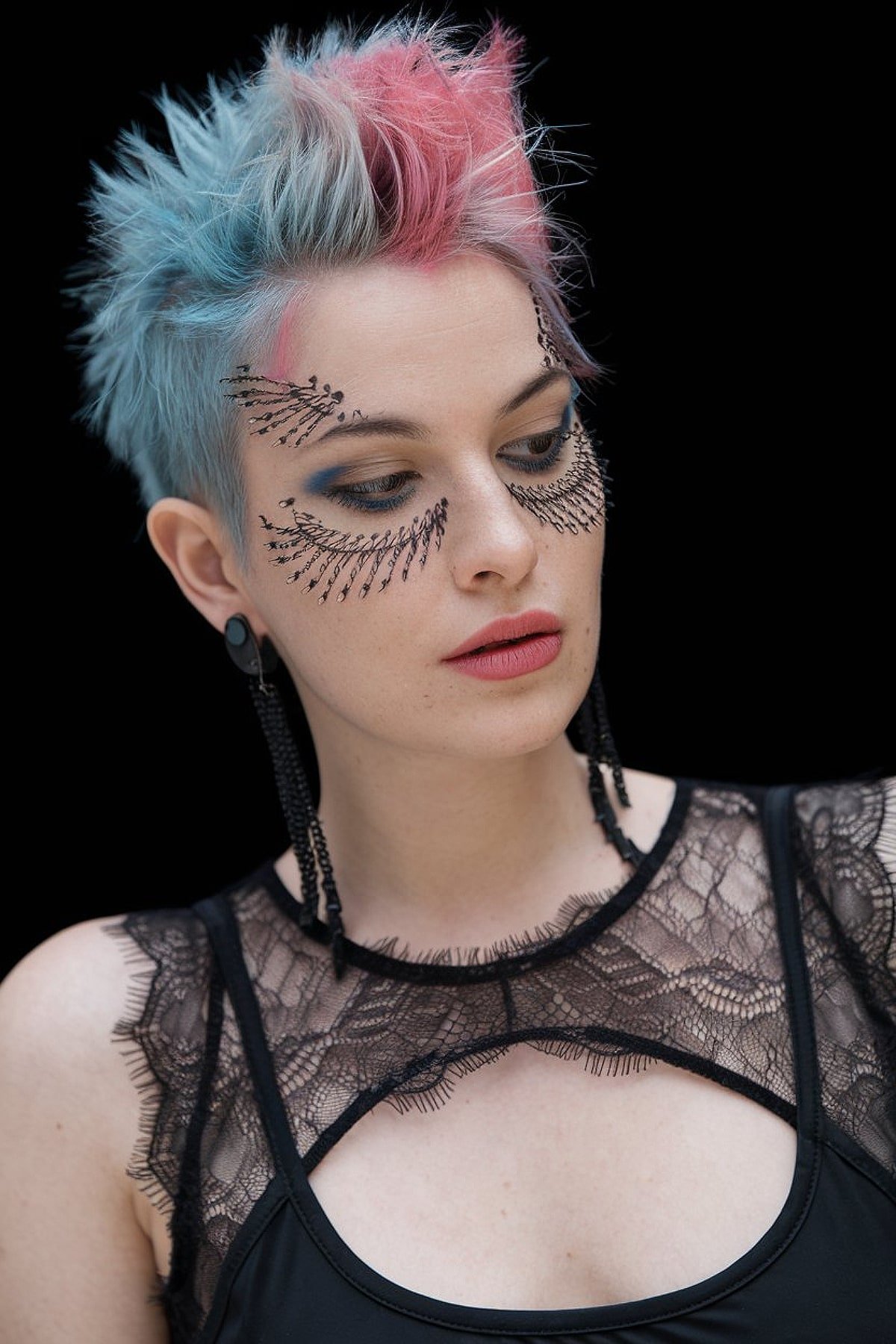 Short pixie cut with blue and pink highlights for a bold Halloween style