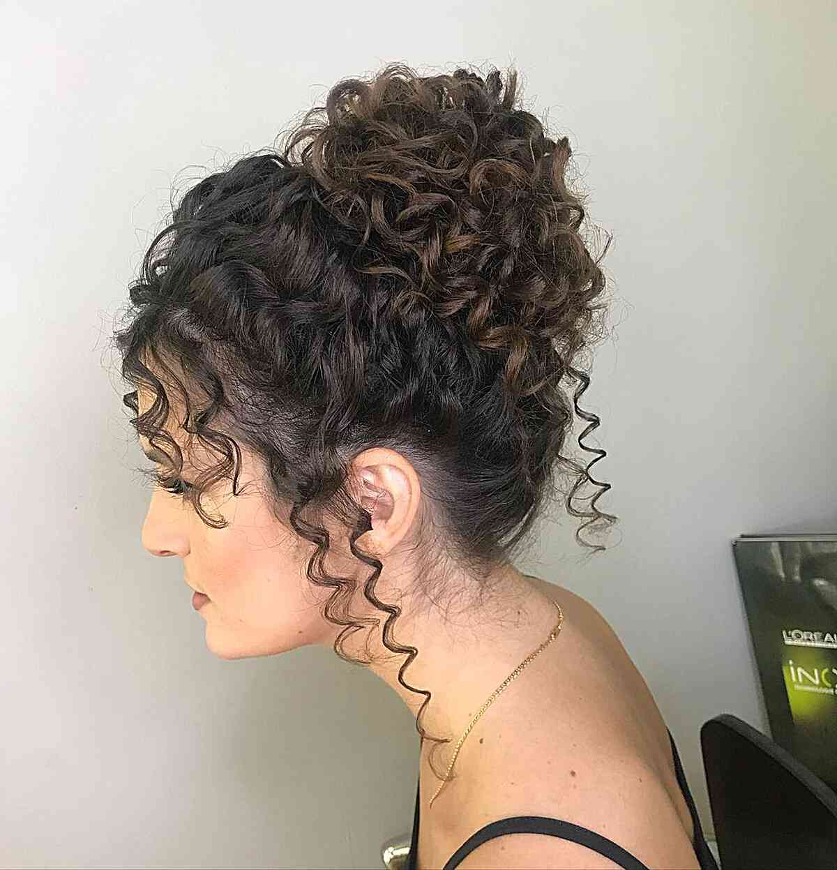 High Chignon with Defined Curls and tendrils for prom night