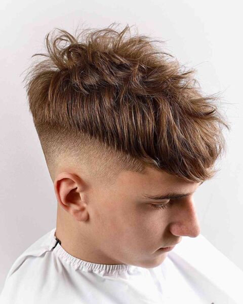 A High Fade with a Messy Long Top for Teen Boys with Low Bald Fade