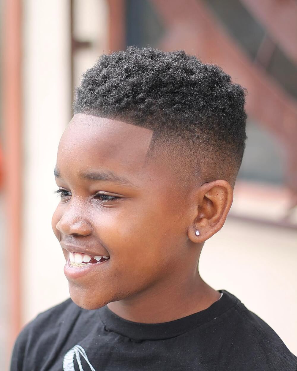 A high skin fade haircut with twists for little black boys