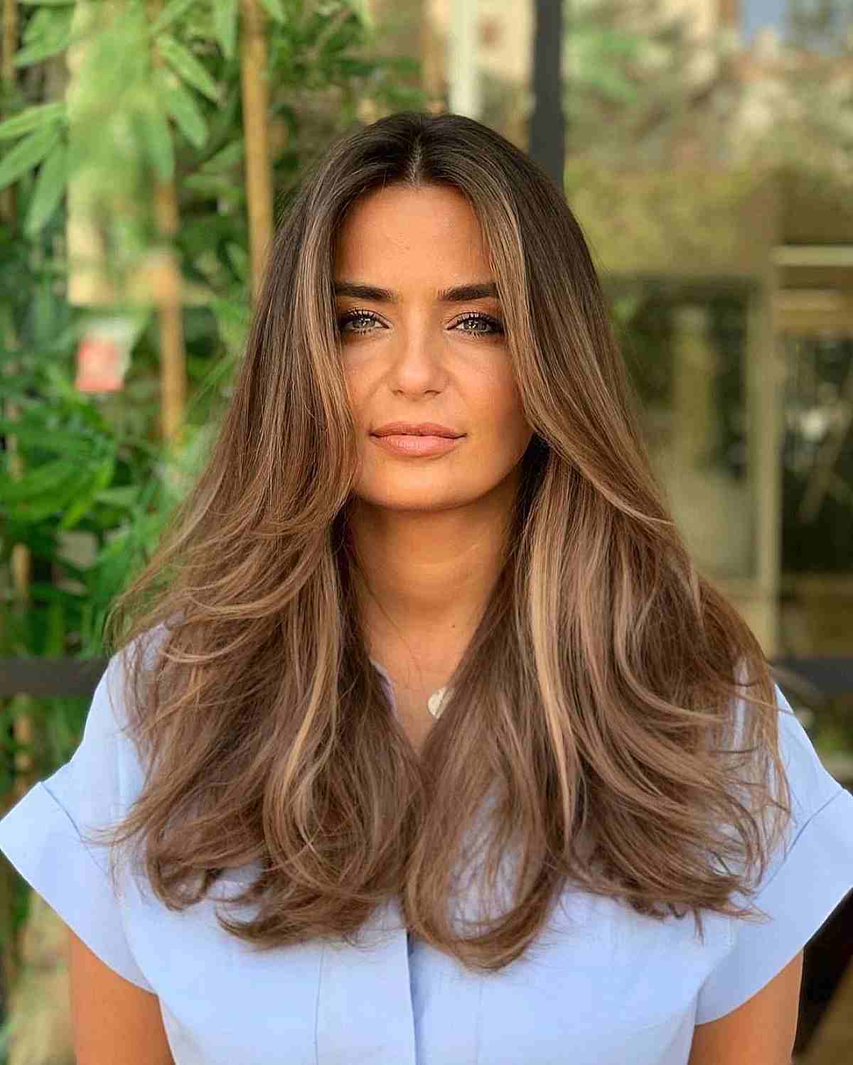 Highlighted Brunette Thick Hair with Swoopy Layers