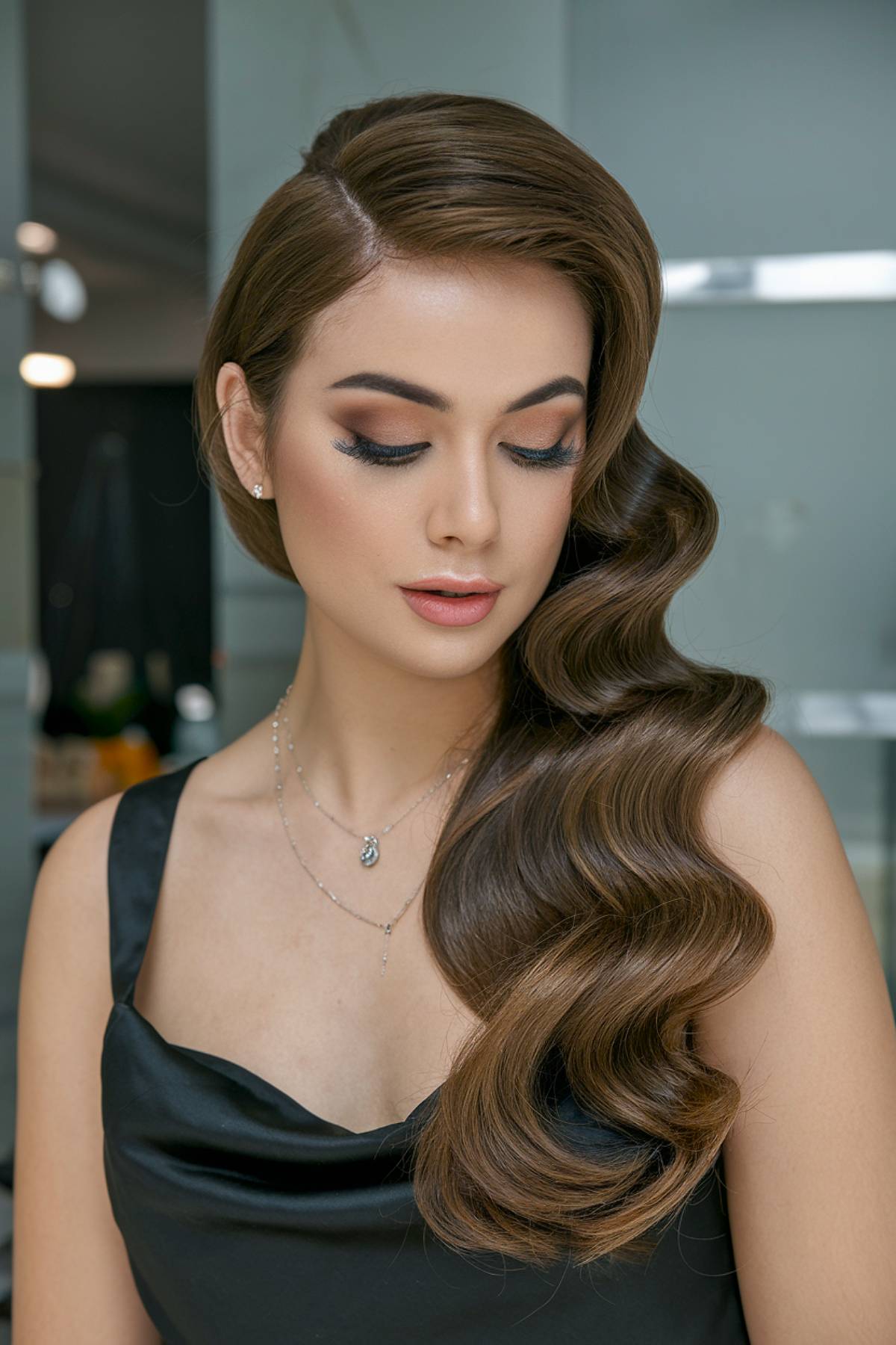 Classic Hollywood waves with a deep side part and a silky, glossy finish for a vintage glam effect