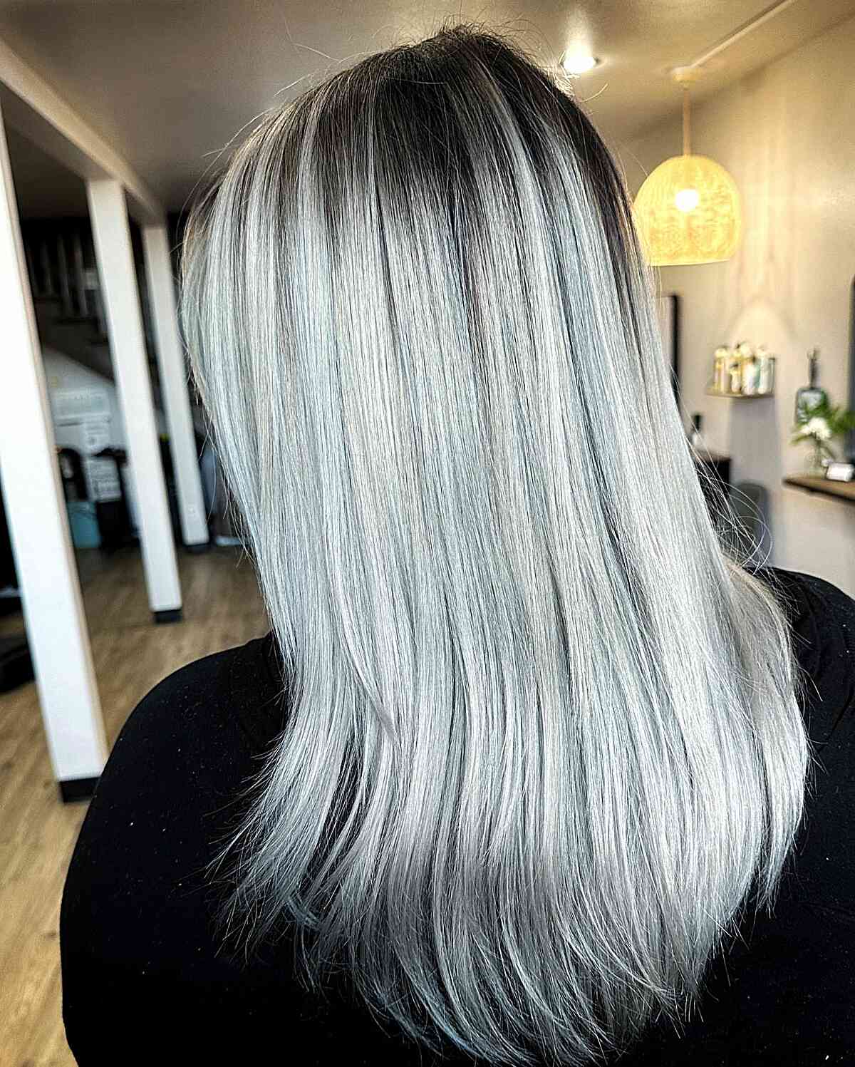 Icy Silver with Black Roots on Mid-Length Hair with Wispy Layers 